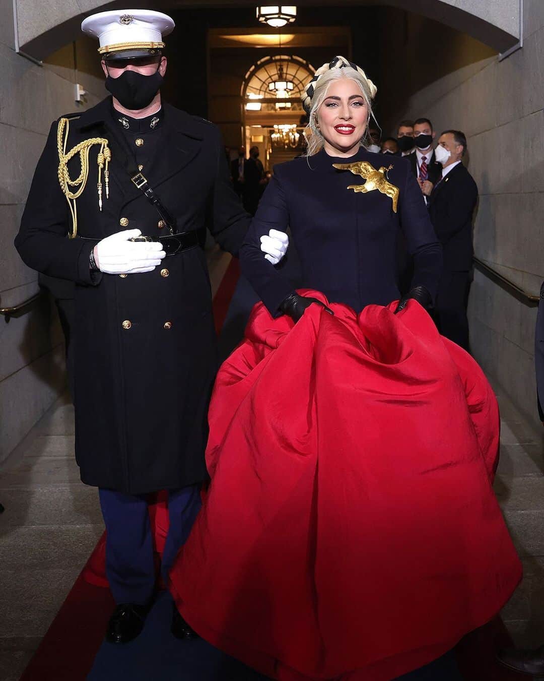 Fashion Weekのインスタグラム：「@ladygaga's fashion choices always make a statement. For her performance of 'The Star Spangled Banner' at the US inauguration, she selected a custom @schiaparelli haute couture design, completed with a gilded dove of peace brooch. Photo by @gettyimages」