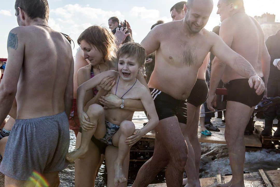thephotosocietyさんのインスタグラム写真 - (thephotosocietyInstagram)「Photo by Brendan Hoffman @hoffmanbrendan // A young boy shrieks after being taken for a quick dip in the icy Dnipro River on Epiphany in Kyiv, Ukraine. The Epiphany holiday, celebrated each January 19 in these parts, commemorates the baptism of Jesus for Orthodox Christians, who plunge themselves into holes cut in frozen lakes and rivers across the country to symbolically wash away their sins after the water is blessed by a priest. Follow me @hoffmanbrendan for more human stories from around the world. #kyiv #ukraine #orthodox #epiphany」1月21日 8時23分 - thephotosociety