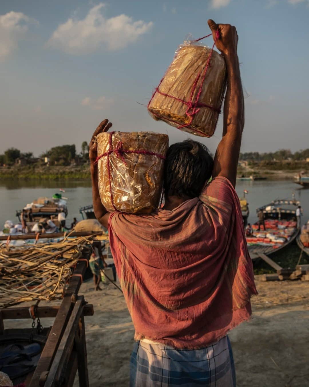 ナショナルジオグラフィックさんのインスタグラム写真 - (ナショナルジオグラフィックInstagram)「Photo by @johnstanmeyer / A laborer carries heavy loads of sweetened cane sugar, called jaggery, to a boat that will ferry them from Dhuburi to one of many remote villages along the Brahmaputra River in the state of Assam, India. Waterways are the lifeline for goods and supplies as well as transport across northern India. The image is from my latest story in the @natgeo August 2020 issue, "Water Everywhere, and Nowhere." @outofedenwalk #walkingindia #edenwalk #india #assam #dhuburi  Check out Nat Geo's link in bio for more on this story.」1月21日 16時39分 - natgeo