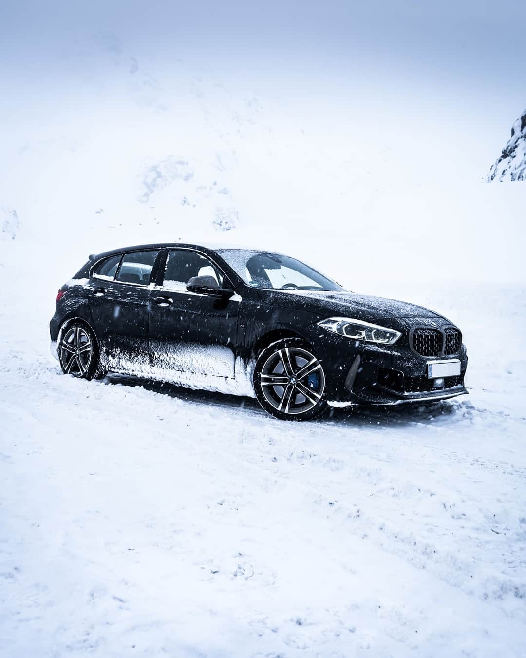 BMWのインスタグラム：「There is no winter without snow, no spring without sunshine, and no happiness without companions. The BMW 1 Series. #THE1 #BMW #1Series #BMWrepost @bmwnefzgerlicious @dschmdt __ BMW M135i xDrive: Fuel consumption weighted combined in l/100km: 6.7–6.3 (NEDC); 7.8–7.3 (WLTP), CO2 emissions weighted combined in g/km: 155–145 (NEDC); 178–167 (WLTP). Further information: www.bmw.com/disclaimer.   306 hp, 225 kW, 450 Nm, Acceleration (0-100 km/h): 4.8 s, Top speed (limited): 250 km/h.」