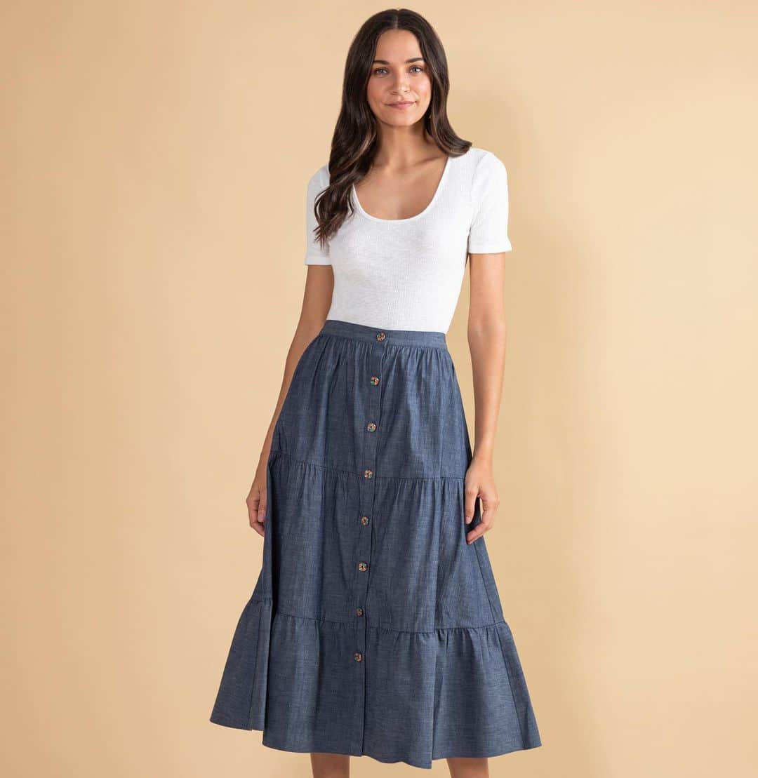 のインスタグラム：「Denim kind of day in the Basset Skirt. Swipe right for a closer look at the 🌈 buttons! #shoshanna #resort2021 #resort #denim #rainbow」