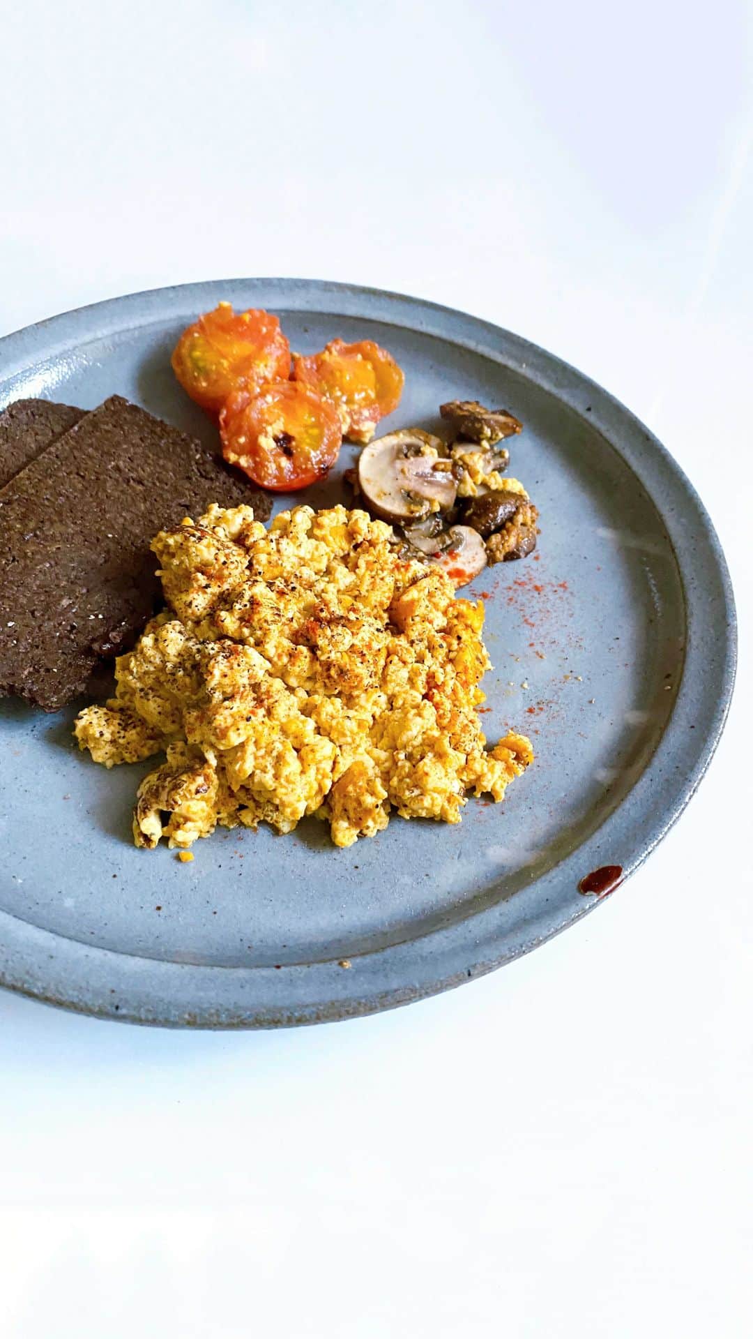 ケリーのインスタグラム：「豆腐スクランブル   2人分材料  豆腐木綿  250gr ターメリックパウダー　　　　　　　小さじ1/3 ガーリックパウダー　　　　　　　　小さじ1/3 パプリカパウダー　　　　　　　　　小さじ1/3 塩　　　　　　　　　　　　　　　　小さじ1/4 胡椒　　　　　　　　　　　　　　　小さじ1/4 オリブオイル　　　　　　　　　　　小さじ1 ミニトマト　　　　　　　　　　　　3-4個 マッシュルーム　　　　　　　　　　3-4個  作り方  ⑴ お豆腐の水切りを前日の夜から 水切りしてください。 ⑵  豆腐を手でちぎりボールの中に入れ、 オリブオイル以外の材料を加えて よく混ぜ合わせる。 ⑶ フライパンにオリブオイルを中火で熱して、⑵を加えて、お豆腐の水分なくなるまで炒める。 ⑷ フライパンの中に⑶をサイドにして、トマト、マッシュルームを入れて、塩とオリブオイルを少し振りソテーしてから完成❣️  ＊豆腐スクランブルと好みのトーストと 一緒に召し上がれ😋😍  Tofu Scramble   ingredients for 2 persons   250gr  Extra Firm Tofu 1/3  Turmeric powder  1/3  Garlic  powder  1/3  Paprika powder  1/4  Salt 1/4  Paper 1 tbsp  Olive oil  3-4  Mini Tomatoes  3-4  Brown Mushrooms  Instructions  ・ 1) Pat tofu dry and roll in a clean, absorbent kitchen paper towel with something heavy on top, and keep in the fridge over night.   2) use your hands to break up the tofu in a small bowl with the ingredients besides the olive oil and mix it well.   3) Heat the olive oil in a pan over medium heat add in the tofu and cook on medium heat until most of the water has evaporated.   4) on the side of the fry pan add  the tomato and mushrooms salted with a bit of salt and drizzle some olive oil and sautéed.   * Serve with your favorite toast and enjoy it😋  #kellysrecipebitoremeshi #ケリーレシピ美トレめし」
