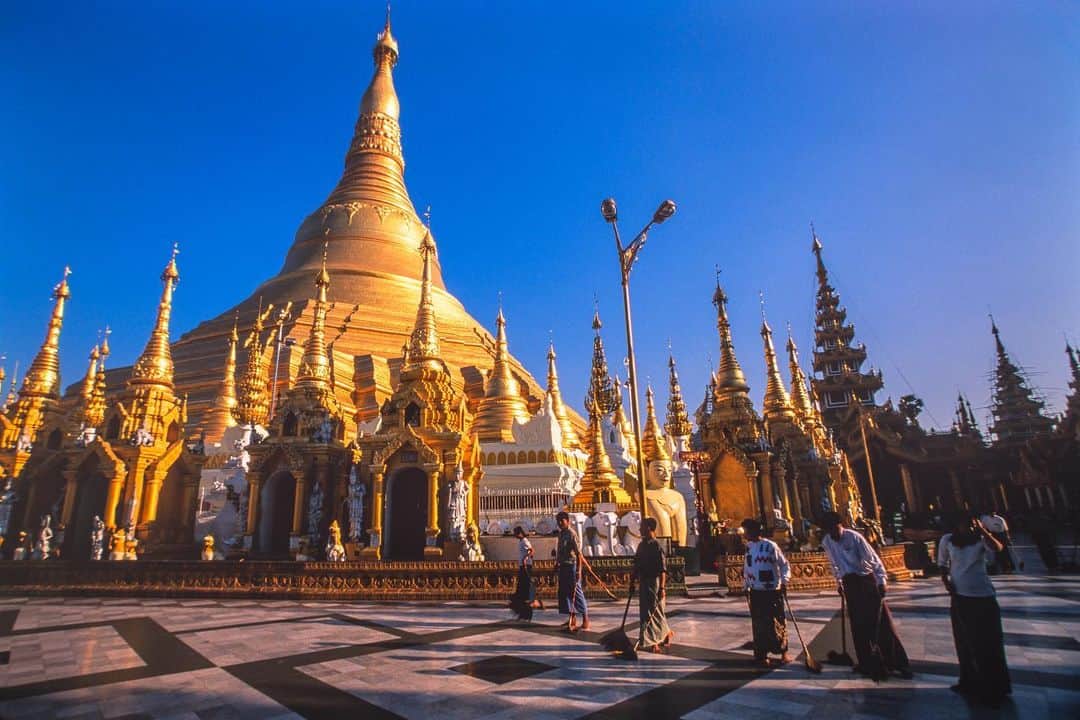Michael Yamashitaのインスタグラム：「Some things don’t change: The 2600-year old Shwedagon Pagoda, photographed on my first trip to Myanmar in 2001, is the oldest in Myanmar. Every morning at sunrise, the Buddhist faithful volunteer to sweep the grounds of the country's most sacred site. The gilded 170-meter pagoda, now a World Heritage site, sits atop a 50-meter hill dominating the Yangon skyline. On my first visit, photojournalists were not permitted to enter the country. The same restrictions on working journalists are in place today, and are expected to get more stringent, now that the military has seized power of the government. #shwedagonpagoda #shwedagon #yangonlife #yangon #myanmar #worldheritagesite」