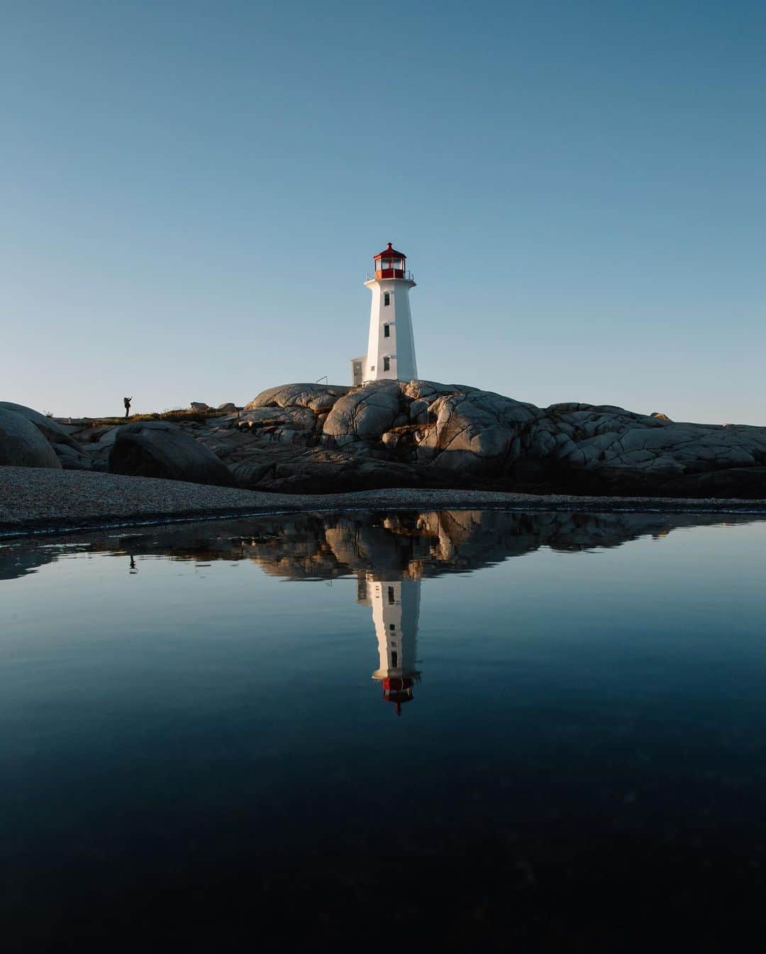 National Geographic Travelさんのインスタグラム写真 - (National Geographic TravelInstagram)「Photos by @MichaelGeorge / Peggy’s Point Lighthouse. Five times. In different light. With different people. Reflected in water. Which is your favorite? The rocks around her look like beached whales. Up close, she’s a little run down, but within the scenery she makes herself an icon. It gets cold quickly here, the moment the sun disappears. Despite the still water in the many puddles, the ocean is ever raging and threatens to sweep photographers’ tripods far, far away. I always love the meditation of photographing the same thing in countless different ways, searching for the perspective that ends up being “the one.” For more photos and writing from my travels, follow along @MichaelGeorge. #peggyspointlighthouse #lighthouse #peggyscove #halifax #novascotia」1月26日 4時37分 - natgeotravel
