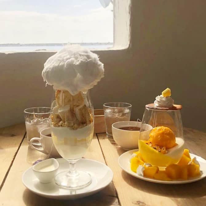 のインスタグラム：「［#cafemiru_沖縄］ —————————————————————— 1日100食限定のパフェ専門店🌈「JET SWEETS」  わたあめが乗った冬限定のパフェ😎🎉地中海を彷彿とさせる店内で、ゆったりなひとときをお過ごしいただけますよっ☺️✨  ☑冬のホワイトパフェ☃️（冬季限定） ☑マンゴーパフェ🥭 ※販売状況は事前にお店へご確認ください。  📍JET SWEETS ⚪︎住所 / 沖縄県沖縄市泡瀬3-47-1 2F ⚪︎営業時間 / 【月〜日】7:00〜22:00(なくなり次第終了) ※現在は営業時間が異なる場合がございますので、事前にご確認ください。 ⚪︎定休日 / 不定休 ⚪︎アクセス / 沖縄市中心部より車で15分  【#cafemiru_Okinawa】 📍JET SWEETS ◎Open Hours / 【MON-SUN】7:00〜22:00 ◎closest station / Car only  ☕️&📷 @jet_sweets_ —————————————————﻿—— Cafemiruでは「#インスタ探検隊」or「#cafemiru」をタグ付けしているカフェ写真から、運営スタッフが厳選してご紹介しています👀🔍﻿」