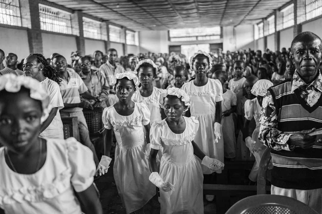 thephotosocietyさんのインスタグラム写真 - (thephotosocietyInstagram)「Photo by Michael Christopher Brown @michaelchristopherbrown. A wedding procession at a Catholic Church in Lulingu, South Kivu, Democratic Republic of the Congo. Roughly half the Congolese population is Catholic, with 6 archdioceses and 41 dioceses. Described by Michael G Schatzberg as the "only truly national institution apart from the state,” Catholic schools have educated over 60 percent of the nation's primary school students and more than 40 percent of its secondary students. The church owns and manages an extensive network of hospitals, schools, and clinics, as well as many diocesan economic enterprises, including farms, ranches, stores, and artisans' shops.」1月26日 23時46分 - thephotosociety