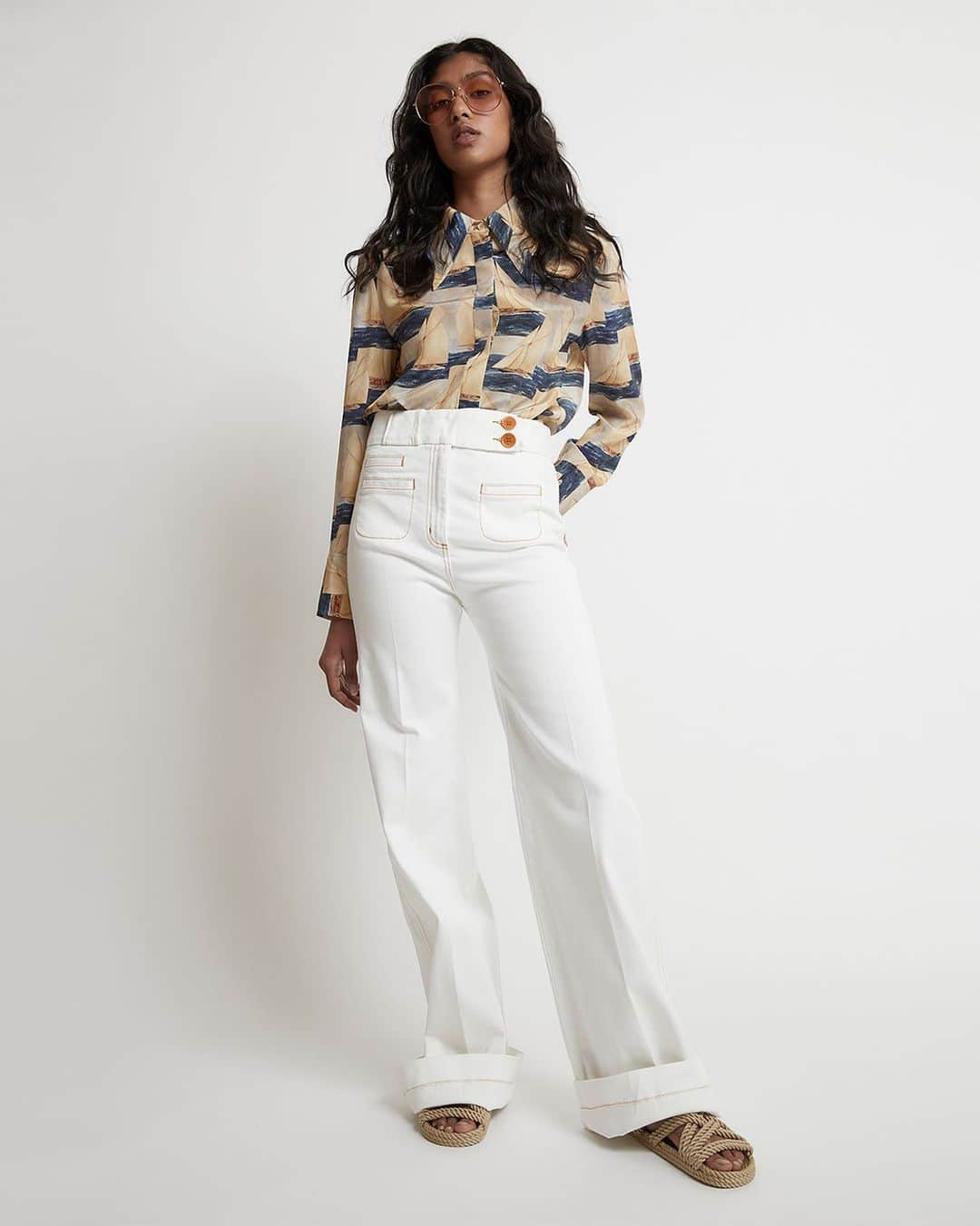 カレンウォーカーのインスタグラム：「Irene wears our silk Crêpe de Chine Britannia Harbour Shirt and organic cotton Starboard Flares. This re-cut of a Karen Walker classic is produced to the @maeka_standard by the team at @OutlandDenim. We’re thrilled to be the first label to work with Maeka and play a part in expanding their social impact. Whilst ensuring long-term employment for those in vulnerable communities, Maeka provides responsible sourcing and sustainability reporting support, tracking technology, for true social and environmental impact.」