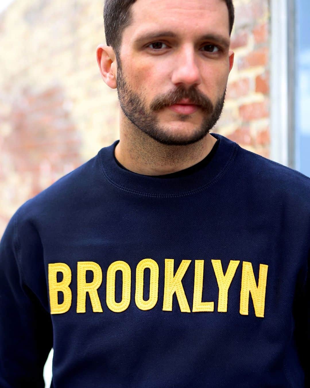 ブルックリンインダストリーズのインスタグラム：「Blake in the new Captain Crew Neck. Tap to shop these appliqued in the USA sweatshirts. #liveworkcreate #brooklynindustries #mensfashion」