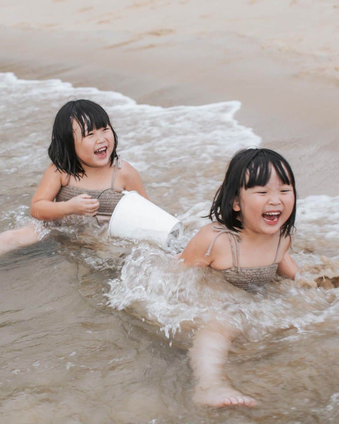 MOMOツインズのインスタグラム：「The girls would give anything for beach days. Other than food, you’ll find them the happiest sitting on the shoreline enjoying the waves, digging in the sand and having a carefree good time. It was a sensory experience for Luke who enjoyed touching the sand but got a little overwhelmed with the waves. Looks like we have to be back soon!  #vitaminsea🌊」