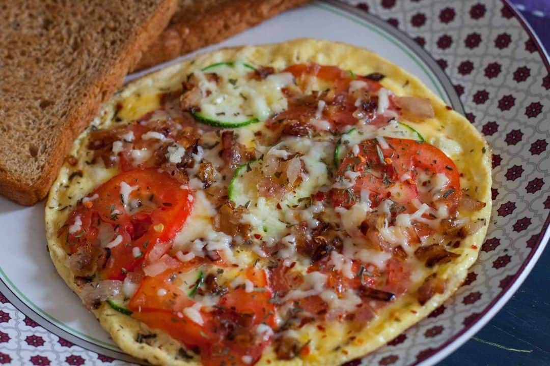Archana's Kitchenさんのインスタグラム写真 - (Archana's KitchenInstagram)「Start your Saturday with this delicious frittata stuffed with fresh juicy tomatoes, zucchini slices seasoned with oregano, thyme and red chili flakes. Serve with a smoothie and a toast by the side for a filling breakfast :) Get the recipe from the smart.bio link in my profile @archanaskitchen . . . . . #recipes #easyrecipes #breakfast #Indianbreakfast #archanaskitchen #healthyeating #highprotein #breakfastclub #dosa #dosarecipes #dosabatter #ragi #ragidosa #mysoremasaladosa #homemadefood #eatfit #cooking #food #healthyrecipes #foodphotography #recipeoftheday #comfortfood #deliciousfood #delicious #instayum」1月30日 11時30分 - archanaskitchen