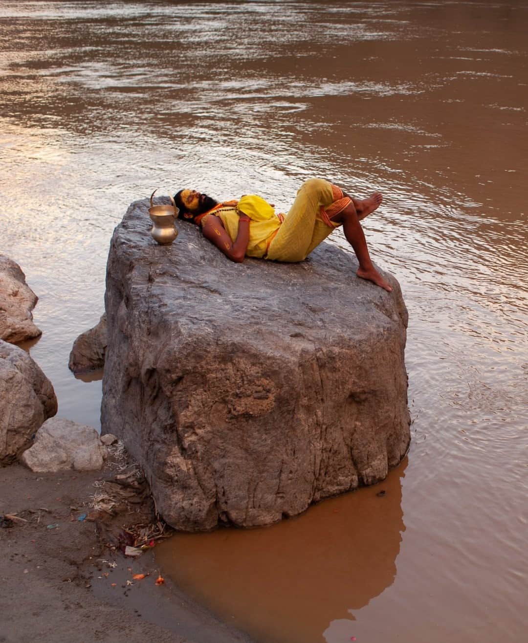 National Geographic Travelさんのインスタグラム写真 - (National Geographic TravelInstagram)「Photo by @joshuacogan/ A sadhu rests upon a river stone in Rishikesh. These headwaters of the Ganges hold deep significance as a place of pilgrimage and prayer for the Hindu faith. It's one of the places I most long to travel back to when the world opens up again, to see what has changed and what remains the same. For now, I will have to meet the people I've connected to there in the space of dreams.  For more journeys inward and outward, follow me @joshuacogan.」1月30日 20時38分 - natgeotravel