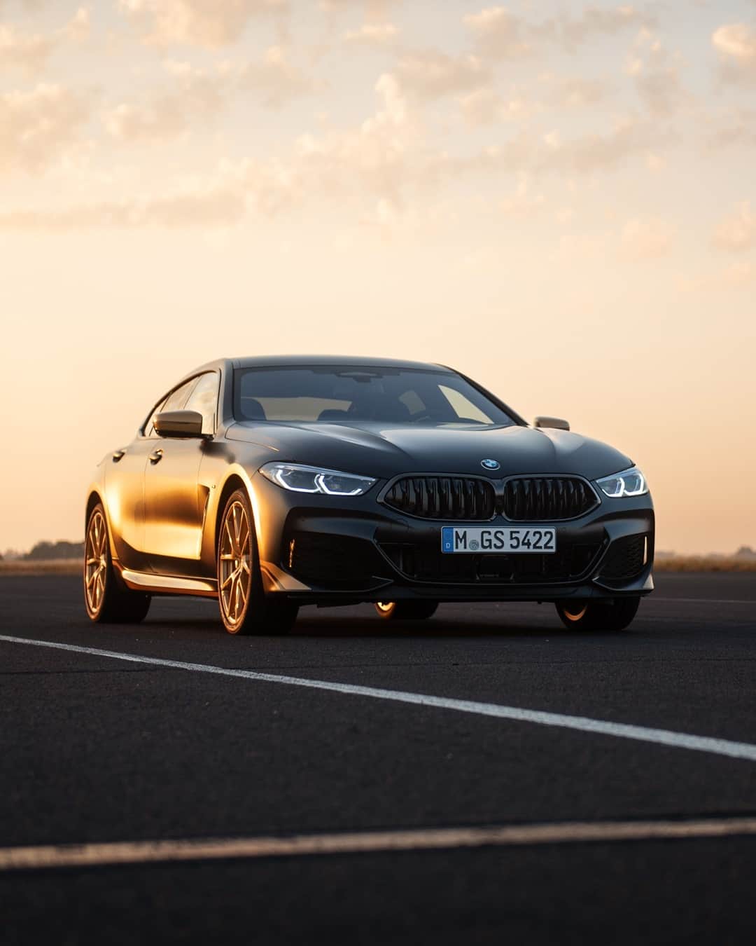 BMWのインスタグラム：「Touched by thunder.  The BMW 8 Series Golden Thunder Edition. #THE8 #BMW #8Series __ BMW M850i xDrive Coupé: Fuel consumption weighted combined in l/100km: 10.0–9.9 (NEDC); 10.8–10.7 (WLTP), CO2 emissions weighted combined in g/km: 227–224 (NEDC); 247–244 (WLTP). Further information: www.bmw.com/disclaimer.   530 hp, 390 kW, 750 Nm, Acceleration (0-100 km/h): 3.7 s, Top speed (limited): 250 km/h.」