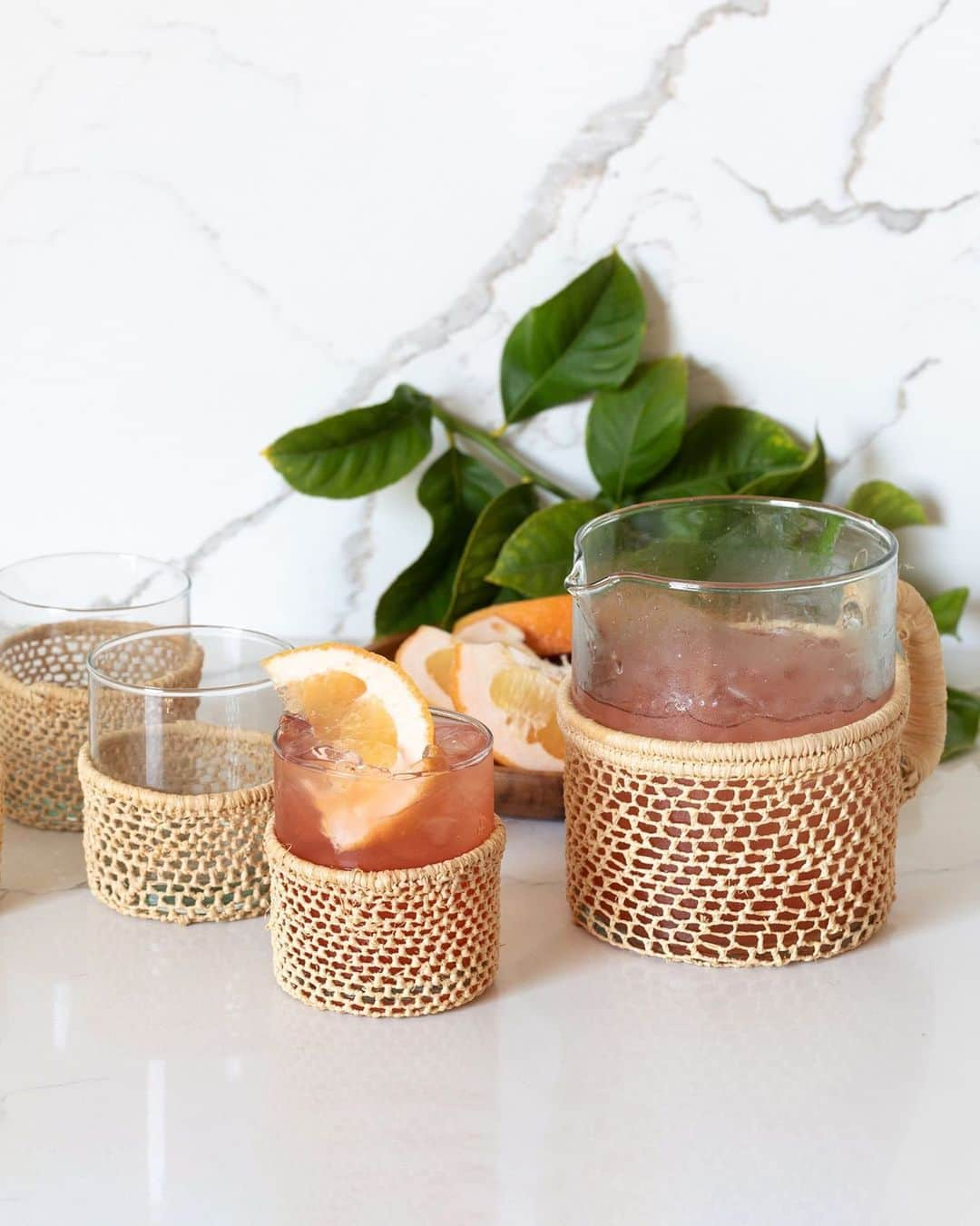 The Little Marketのインスタグラム：「Serve up refreshing drinks in style with our woven pitcher and matching glassware. Their unique shape is complemented with hand-braided raffia fibers for a truly special set. Tap to shop.」