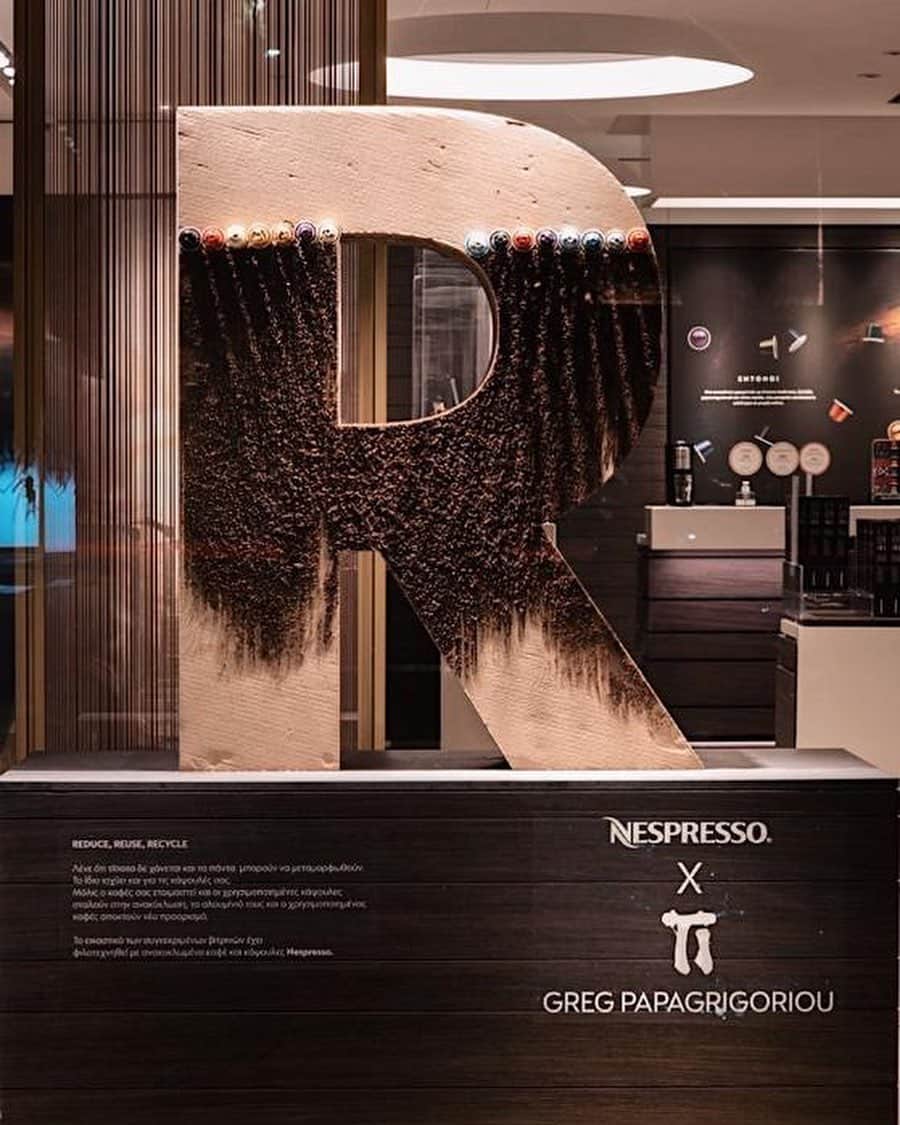 Nespressoのインスタグラム：「One statement, one artist, one rule:   We have asked local artists around the world to express their views on how #DoingIsEverything –  by each creating sustainable #NespressoWindows with upcycled materials. 🌏♻️  🇬🇷 Greece  #DoingIsEverything by artist @greg_papagrigoriou in our Athens Glyfada Boutique.​   Visual artist Grigoris Papagrigoriou’s display is entirely made out of sustainable and recycled material.  The artist plays with recycled capsules and coffee ground, transformed into a ‘new paint’ — to illustrate the earth at the center of a “Doing is Everything” cardboard-letter installation.   The work celebrates the importance of recycling and keeping the earth at the center of all our initiatives.   #Nespresso #NespressoWindows #DoingIsEverything」