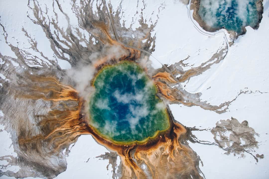 National Geographic Travelさんのインスタグラム写真 - (National Geographic TravelInstagram)「Photo by @max.lowe / From the edge of the boiling depths of the Grand Prismatic Spring in Yellowstone National Park, you can see indistinct color, often shrouded by the steam pouring from the top of the thermal feature. From above, though, it transforms into a beautiful emerald—a reminder that perspective changes everything. This was shot from a fixed-wing aircraft at 2,000 feet (610 meters). To see more from winter in Yellowstone, follow @max.lowe.」3月1日 12時35分 - natgeotravel