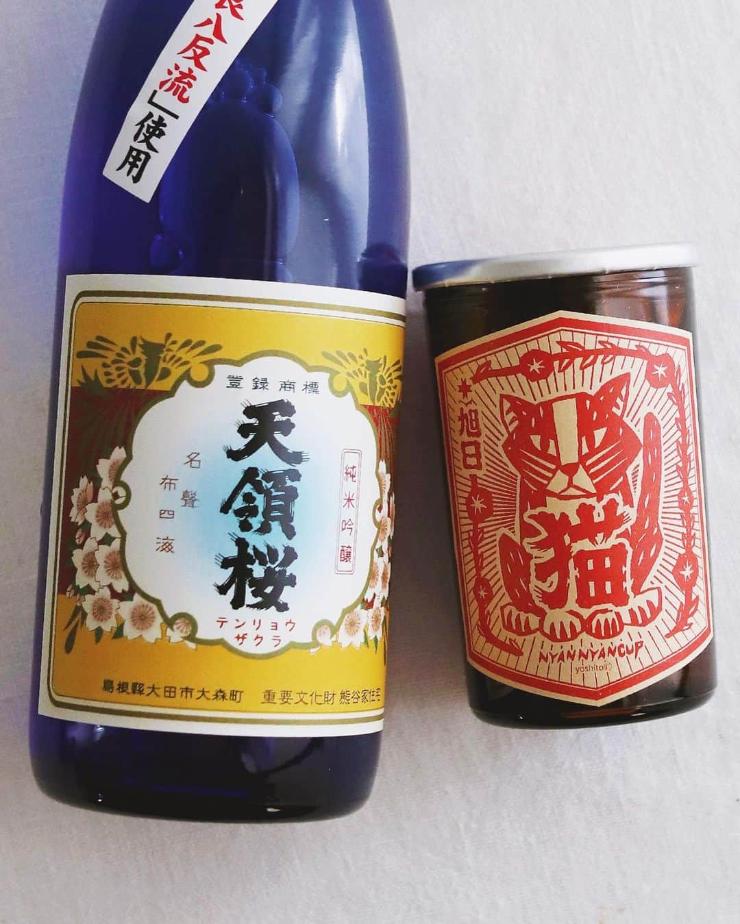 樋口正樹さんのインスタグラム写真 - (樋口正樹Instagram)「🍶 #勝手に日本酒マラソン . ２月の日本酒に２本が かおしさんチョイスで 追加で召集されました。 👉@cao_life . 左は島根県の太田市の 一宮酒造のレアな一本 純米吟醸の天領桜です。 . 真ん中のワンカップは、 同じ島根県で出雲市の 旭日酒造さんの純米酒 十旭日のワンカップの にゃんにゃんカップで、 動物愛護の支援酒です。 犬バージョンもあるよ☝️ . 右はおまけのボナさん。 横にさっと置いたので かなりブレてますけど😅 . . #一宮酒造 #天領桜 #旭日酒造 #十旭日 #にゃんにゃんカップ #アニマルレスキュードリームロード #島根県のお酒 #島根の地酒 #島根県 #純米酒 #純米吟醸 #飲み比べ #日本酒 #日本酒好き #日本酒飲み比べ #日本酒男子 #日本酒好きな人と繋がりたい #日本酒で乾杯 #備忘録 #お酒の備忘録 #jujiasahi #sake」2月8日 17時17分 - higuccini