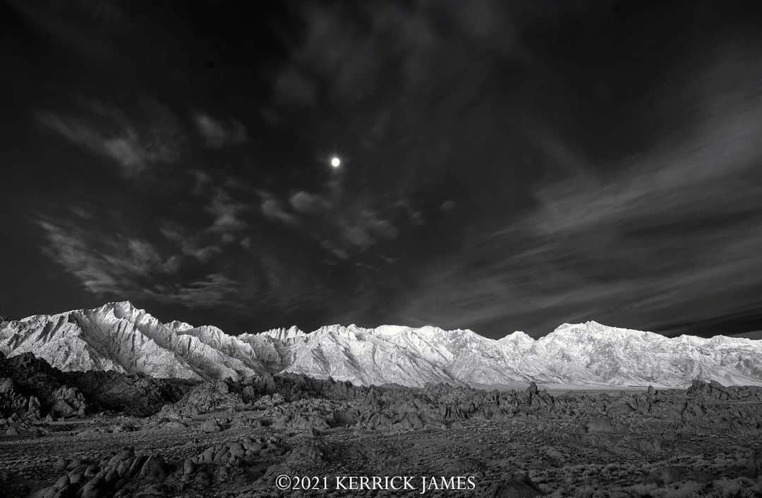Ricoh Imagingのインスタグラム：「“I'm on a long loping road trip in California with my great longtime friend Joel Grimes, roaming for light and discovery. Here is one, the moon setting at sunrise over the Sierra Crest, from the Alabama Hills near Lone Pine. Shot with the Pentax K-01 and 15mm Limited lens, (body modified for Deep Infrared Monochrome). Thank you Joel!” @kerrickjames5」