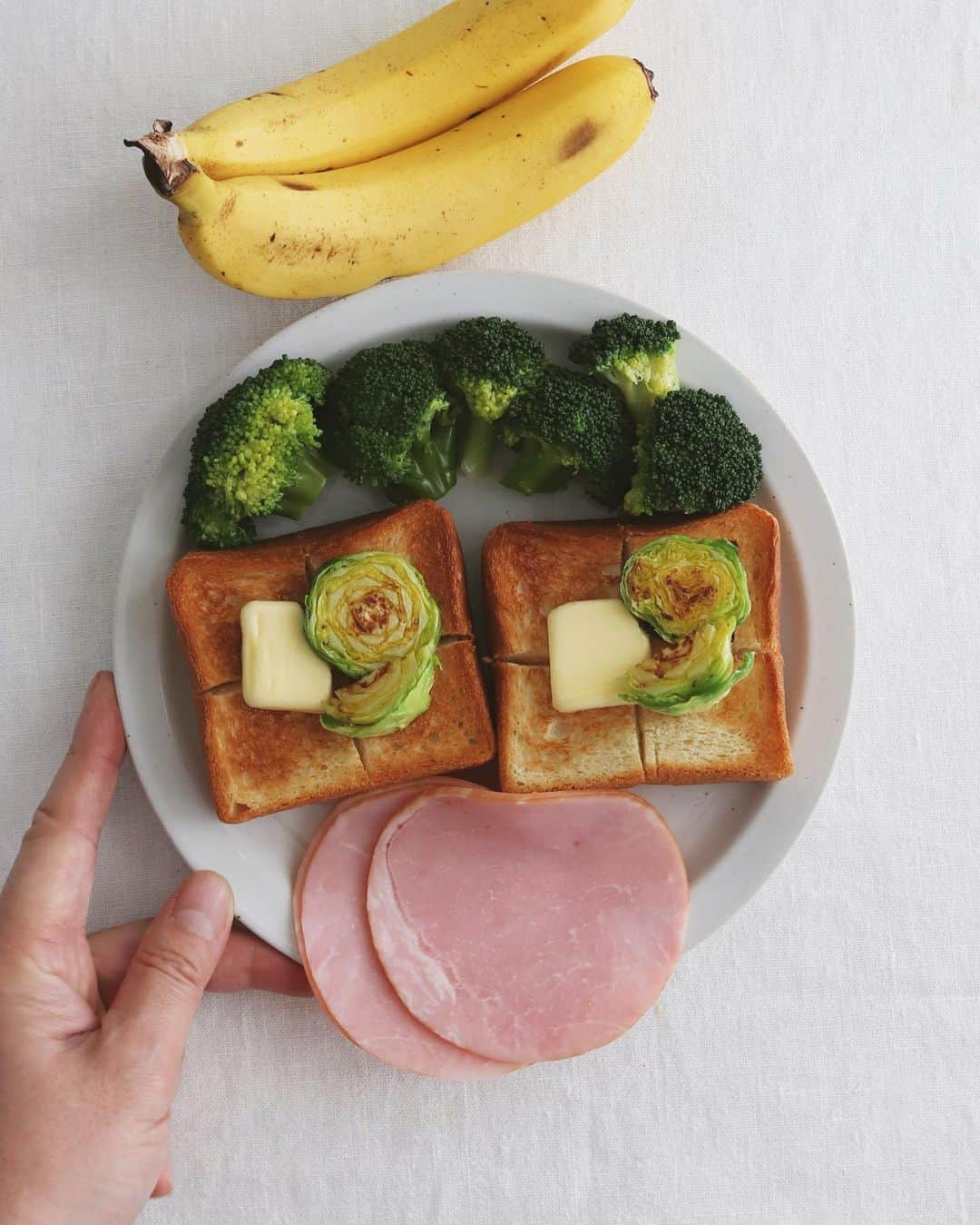樋口正樹さんのインスタグラム写真 - (樋口正樹Instagram)「Today's breakfast . 今朝はパンにバターと 炒めた芽キャベツのせ、 ハムとブロッコリーを ワンプレートに盛って、 バナナを添えてみたら なんとなく陽気な顔に😅 . . #おはようございます #自粛疲れ #朝ごはん #朝食 #ワンプレート朝ごはん #パン #ハム #ブロッコリー #芽キャベツ #バナナ # #変な顔 #陽気なやつ #並べるシリーズ #breakfast」2月9日 7時53分 - higuccini