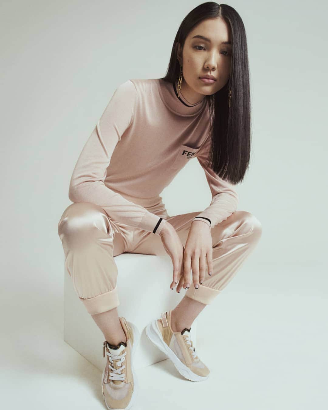 Fendiのインスタグラム：「Sumptuous separates and iconic accessories that put a signature #Fendi spin on off-duty dressing. Indulge in the #FendiFW20 luxe loungewear edit – from sporty tops and track pants to the #FendiFlow sneakers, all tinged with the season’s understated blush pink colorway.   Photographer: @yvanfabing Stylist: @giovannidariolaudicina Models: @bibiabdulkadir, Lisa Lu, @brittvdherik_, @zj_zhengjie, @freekiven」
