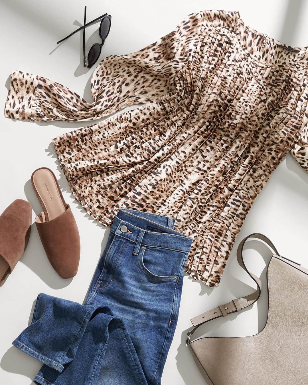 Banana Republic のインスタグラム：「Editor's Select: Pair our Satin Pleated Blouse - shown in Cheetah Print- with our High Rise Straight Denim, suede mules and an elegant shoulder bag to hold all your essentials. Tap to shop this effortlessly chic look.」