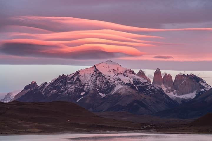 National Geographic Travelさんのインスタグラム写真 - (National Geographic TravelInstagram)「Photo by @daisygilardini / Lenticular clouds appear above Torres del Paine peaks in Patagonia, Chile. A cloud is defined as “a gray or white mass in the sky, made up of very small floating drops of water.” The dictionary doesn’t say much about the beauty of clouds, however. Lenticular clouds are particularly beautiful. They form on top of mountains where there is moisture coupled with strong winds at high altitudes. They are often seen stacked in groups.  Follow me @daisygilardini for more images and behind-the-scenes stories. #cloud #lenticularcloud #patagonia #chile #torresdelpaine」2月11日 12時35分 - natgeotravel