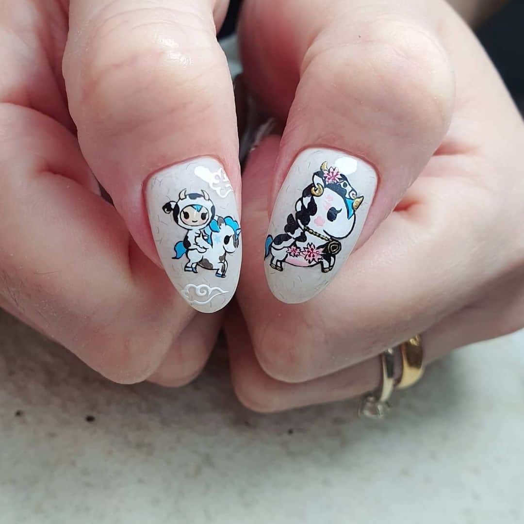 Yingのインスタグラム：「#tokidoki themed CNY nails!   Done on infilled gel sculpture extensions (I used @ericasata Piranha Specialty Carbide to file down the previous set before doing an infill). Base colour is PREGEL Tulle Grege and PREMDOLL MUSE G653. All art done with PREGEL Art Liner gels and Toki Doki characters were predrawn on @tsumekira Plain Sheet.  All items can be purchased at @nailwonderlandsg 🤗 . . . 🛒 www.nailwonderland.com⁣⁣ 📍20A Penhas Road, Singapore 208184⁣⁣ (5 minutes walk from Lavender MRT)⁣⁣ .  I am currently only able to take bookings from my existing pool of customers. If I have slots available for new customers, I will post them on my IG stories. Thank you to everyone who likes my work 🙏 if you need your nails done, please consider booking other artists at @thenailartelier instead ❤  #ネイルデザイン  #ネイルアート #ネイル #ジェルネイル #nailart #네일아트 #pregel #プリジェル #nails #gelnails #sgnails」