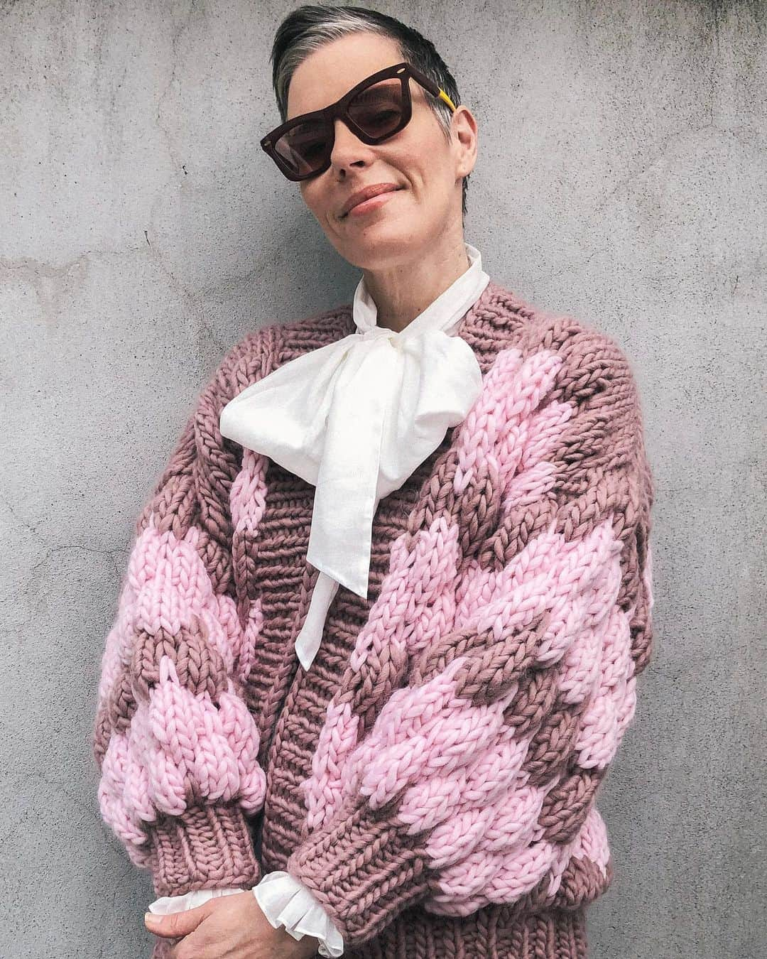 カレンウォーカーのインスタグラム：「@karen_walker wears the @TheKnitter’s ‘Ugly Cardi’. She says “I adore @TheKnitter’s sweaters: the way they manage to be engulfing yet sexy, single-minded yet unexpected, traditionally-made yet thoroughly modern. Most of all I love their craft; the care and love of their design and also their make.​ ​ Anyone who’s ever tried to knit a Peggy square, let alone a sweater; or seen a truly skilled knitter going for it, at pace, will understand that to be able to knit is a gift and a pleasure and thing to be in awe of. Nicole, and her team of incredible craftspeople, all the way across the ocean in Peru, get what it is to make, with love and skill, a truly beautiful thing, one stitch at a time.”​」