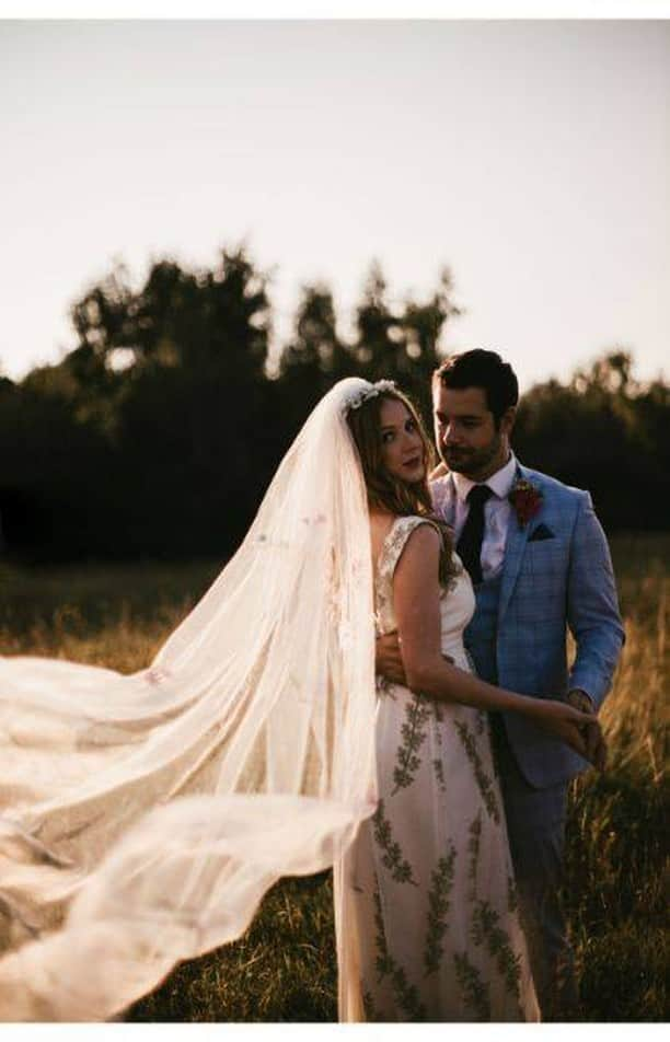 ミナのインスタグラム：「❤ If I was getting married, I would do it like this! ❤  Bell tents, naked cake, relaxed vibe, nature... 😍 See the full gallery of this flower meadow styled shoot on our website. Special shout out to @annemarieprescott_bespokeveils for the incredible veil she provided to this shoot!   Beautiful Cathy is wearing our Fiona dress that has earthy green pussy willows on it. Perfect if you're looking for a non-white wedding dress. Also, the lace is made in Scotland!   Venue @Wellingtonwoodnorfolk  Wedding concept and planner @willowtreewed  Assistant planner @eventsbyeleanor  Photography @katebostonphotography  Film maker @gecko_films_uk  Stylist @smokeandwildwood  Props @arrayweddingandeventhire  Bride @ceemeandtea  Groom @southofnorfolk  Celebrant @jamiewalkercelebrant  Hair Stylist @hair_by_duboux  MUA @emilychantal_mua  Florals @millierose_floral  Cake @mindfulcakes  Suit @vivaldipromenswear  Horsebox photobooth @littlehorsepb  Tableware @aplacesetting  Petal confetti @bymitrefarm  Stationary @leuska_design  Bridal headwear @pswithlov3  Wedding rings @ecowoodrings  Eco glitter @luxurious_glitter  Favours @bombcosmetics @saxonwellbeing   #indiebridelondon #indiebride #bohowedding #outdoorsweddings #countrysidewedding #tipiwedding #teepeewedding #barnwedding #nakedweddingcake #outsidewedding #marqueewedding #gardenwedding #festivalwedding #rusticweddings #rusticchicwedding #rusticweddingchic #countryweddings #countryhousewedding #vintageweddings #vintageweddinginspiration #vintageweddingideas #countrysidewedding #bespokeveil #vintagebride #vintagebrides #vintageweddingdress #vintageweddingdresses #romanticwedding #romanticweddings #romanticbride」