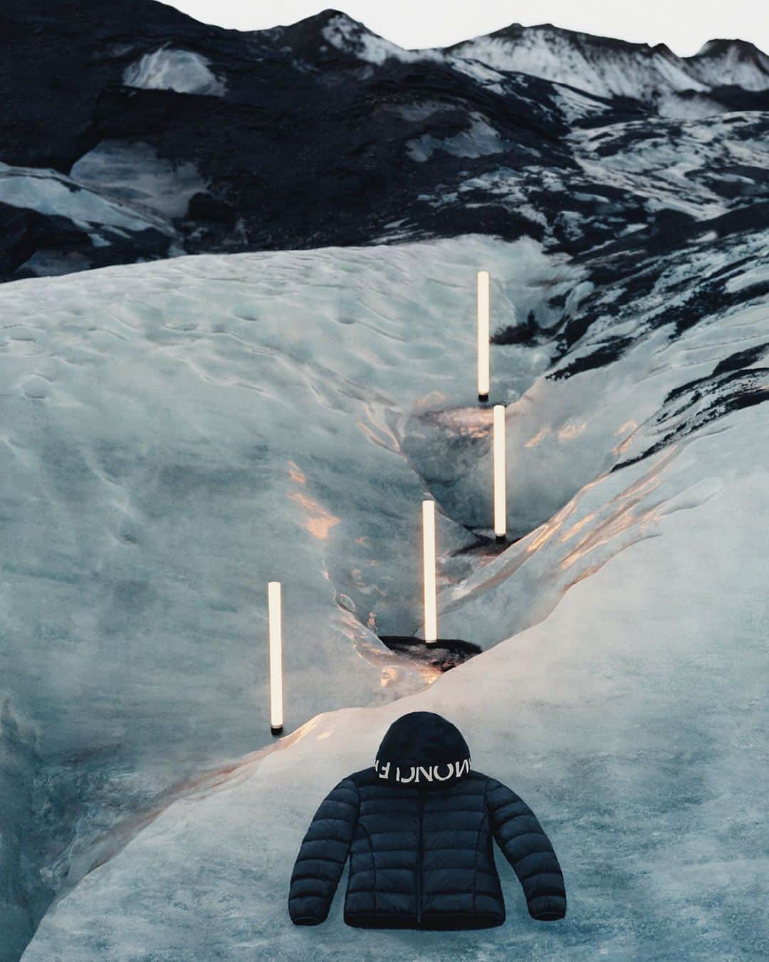 モンクレールのインスタグラム：「Illumination.   Go deeper. Echoing nature’s call of “onward!” @theodegueltzl used staggered lights to draw the eye into the Icelandic landscape. “We were at the edge of a glacier, leading onto the ocean,” he recalls. “We wanted the lights to give a sense of depth, to carry your eyes upwards towards the glacier…”  #MonclerVoices」
