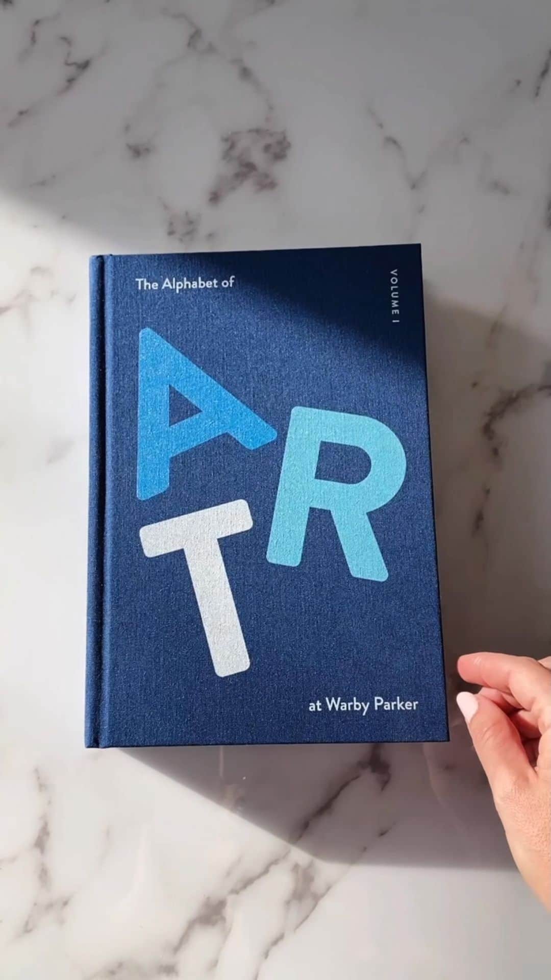 Warby Parkerのインスタグラム：「Introducing our newest book from Warby Parker Press! 📘 “The Alphabet of Art at Warby Parker” is 352 pages of artists and artwork we’ve had the absolute pleasure of showcasing across our world during our first decade 🎨 Another cause for celebration: The book was produced in support of #PupilsProject, our program that provides free eye exams and glasses to public school students in need.  In honor of our 11th birthday, the book is available now exclusively in stores *and* we’re selling 11 copies right here on Instagram. Tap to shop in the Reel. This one’s a feast for the eyes. Bon appétit! UPDATE: All of our stores are fully stocked with “The Alphabet of Art at Warby Parker” but we are sold out on Instagram.」