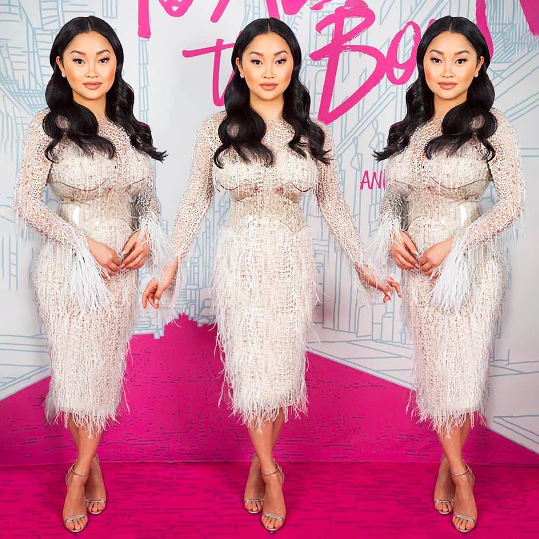 のインスタグラム：「The incredibly talented @lanacondor looking flawless at the virtual premiere of @toalltheboysnetflix wearing a white crystal #JULIENXGABRIELA lace knitted dress with Swarovski Crystals and ostrich feather embroidery, worn with a modernist Perspex belt by @zanabayne and @jimmychoo shoes  Styled by @taraswennen  @julienxgabriela @gabrielagonzalezofficial @netflix」