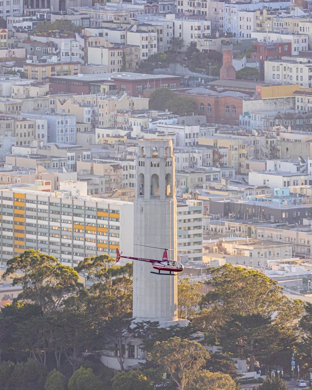 National Geographic Travelさんのインスタグラム写真 - (National Geographic TravelInstagram)「Photo by @tobyharriman / A helicopter tour passes Coit Tower, a popular tourist destination with panoramic views of San Francisco. At sunrise from above, the surrounding neighborhood looked like a palette of pastel paints! Follow @tobyharriman for more. #SanFrancisco」2月19日 0時37分 - natgeotravel