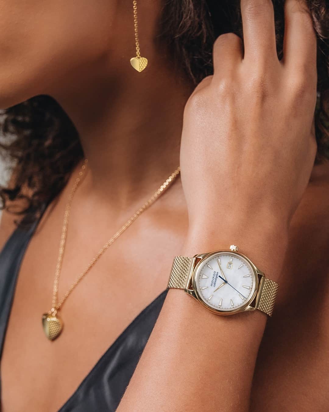 モバードのインスタグラム：「Decked out from head to...wrist. The Movado Heart necklace and bracelet pair perfectly with this #MovadoHeritage piece with a beautiful mother of pearl dial. Click the product tags to learn more. #MovadoJewelry」