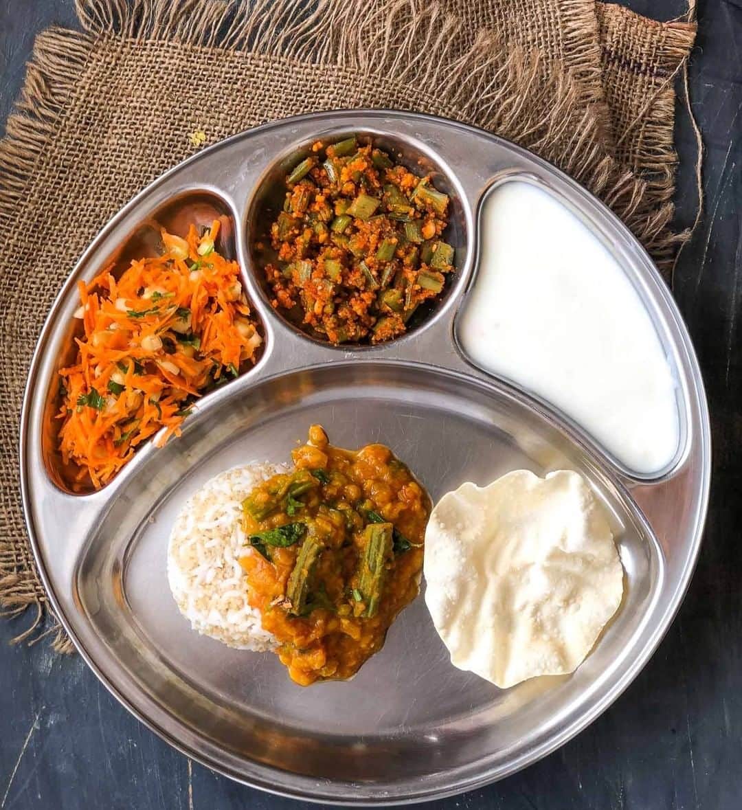 Archana's Kitchenのインスタグラム：「This week's Portion Control Meal Plate is comforting and delicious, made of Drumstick Dal, Goru chikkudukaya which is cluster beans with peanuts and a hint of garlic, Quinoa, Papad, Salad & Curd. This is a perfect meal plate for your weekday dinner. It is easy to make and tastes absolutely delicious too.  #archanasportioncontrolmealplates  Search for the article “Portion Control Meal Plate: Drumstick Dal, Goru Chikkudukaya, Rice Quinoa, Vadam, Salad & Curd” in our app. Link to the app in the bio @archanaskitchen」