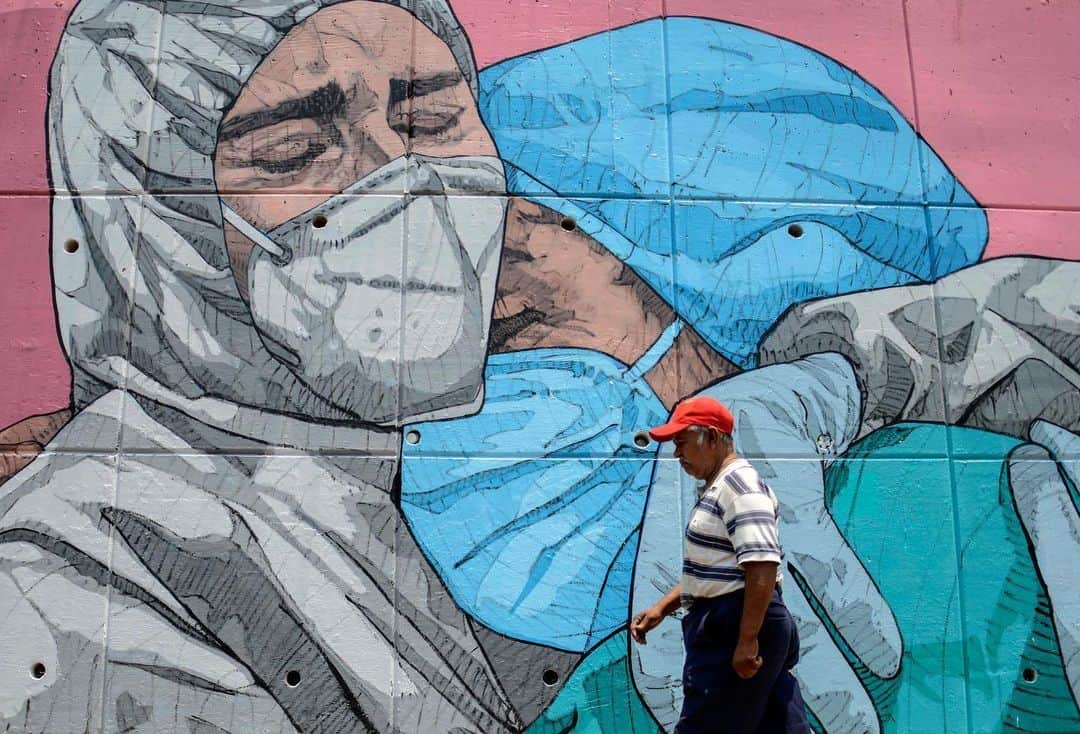 AFP通信さんのインスタグラム写真 - (AFP通信Instagram)「#AFPrepost @aljazeeraenglish - The coronavirus outbreak has inspired some graffiti artists to paint fun or informative works of art on public spaces. Here are some of the graffiti displayed across the globe: ⁠⁠⁣ ⁣  📸Photos: William West, Francisco Robles,  Ina Fassbender, Joseph Eid, Raul arboleda, Mohammed Abed, Mohd Rasfan, Andy Buchanan, Fadel Senna, Nelson Almeida, @afpphoto⁣ .⁠⁠⁣ 1. A woman looks at a mural of a health worker with wings holding a globe in Melbourne, Australia. ⁠⁠⁣ .⁠⁠⁣ 2. A man walks past a coronavirus-related mural, in Acapulco, Guerrero state, Mexico.⁠⁠⁣ .⁠⁠⁣ 3. A boy stands in front of a graffiti painted by artist Kai 'Uzey' Wohlgemuth featuring a nurse as Superwoman on a wall in Hamm, western Germany.⁠⁠⁣ .⁠⁠⁣ 4. A mural depicting a mask-clad boy in front of the Zouk Thermal Power Plant, north of the Lebanese capital Beirut. ⁠⁠⁣ .⁠⁠⁣ 5. A woman wearing a face mask walks next to a painted wall in Bogota, Colombia. ⁠⁠⁣ .⁠⁠⁣ 6. A Palestinian woman walks past a coronavirus-inspired mural in Gaza City. ⁠⁠⁣ .⁠⁠⁣ 7. A medical personnel wearing a protective suit waits at the Covid-19 coronavirus drive-thru test centre outside the Ajwa Private Clinic in Shah Alam on the outskirts of Kuala Lumpur, Malaysia. ⁠⁠⁣ .⁠⁠⁣ 8. A pedestrian walks past graffiti depicting the subjects within famous artworks in Glasgow. ⁠⁠⁣ .⁠⁠⁣ 9. A Moroccan man drives his horse-drawn cart past a mural thanking essential workers in the city of Sale north of the capital. ⁠⁠⁣ .⁠⁠⁣ 10. View of Brazilian mural artist Eduardo Kobra's recent work "Coexistence" which shows children wearing face masks bearing symbols of different religions (L to R) Islam, Buddhism, Christianity, Judaism and Hinduism- in Itu, some 100 km from Sao Paulo, Brazil. ⁠⁠⁣ .⁠⁠⁣ 🔗Tap the link in our bio to learn about how Graffiti tells the story of Egypt’s revolution.⁠⁠⁣ .⁠⁠⁣ #coronavirus #art #graffiti ⁠#health #malaysia #brazil #colombia #morocco #palestine #gaza #germany #lebanon #beirut #mexico #australia⁠⁠」2月25日 2時50分 - afpphoto