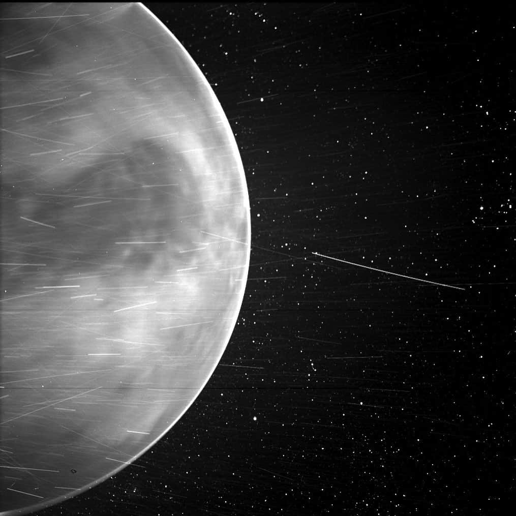 のインスタグラム：「Though NASA's Parker Solar Probe's focus is the Sun, the spacecraft captured stunning views of Venus during its close flyby of the planet in July 2020.   When flying past Venus in July 2020, Parker Solar Probe’s WISPR instrument, short for Wide-field Imager for Parker Solar Probe, detected a bright rim around the edge of the planet that may be nightglow — light emitted by oxygen atoms high in the atmosphere that recombine into molecules in the nightside. The prominent dark feature in the center of the image is Aphrodite Terra, the largest highland region on the Venusian surface. Bright streaks in WISPR, such as the ones seen here, are typically caused by a combination of charged particles — called cosmic rays — sunlight reflected by grains of space dust, and particles of material expelled from the spacecraft’s structures after impact with those dust grains. The number of streaks varies along the orbit or when the spacecraft is traveling at different speeds, and scientists are still in discussion about the specific origins of the streaks here. The dark spot appearing on the lower portion of Venus is an artifact from the WISPR instrument.  Some of the features seen by scientists are labeled in the annotated image. The dark spot appearing on the lower portion of Venus is an artifact from the WISPR instrument.   Read more at the link in our bio.  Credits: NASA/Johns Hopkins APL/Naval Research Laboratory/Guillermo Stenborg and Brendan Gallagher」