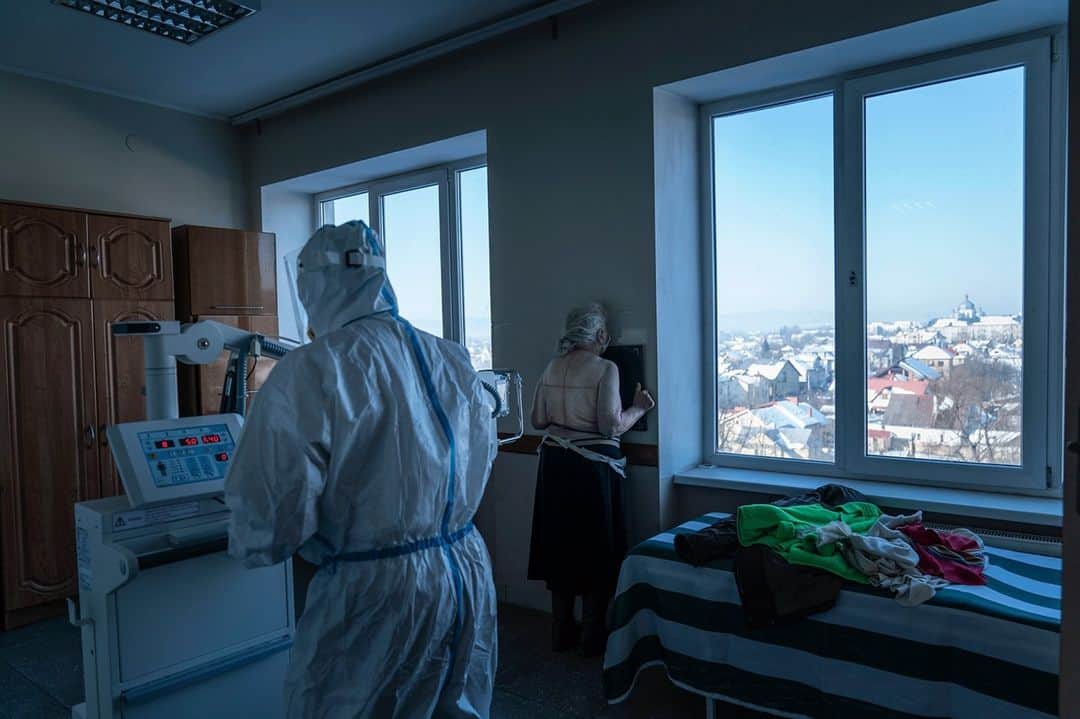 TIME Magazineさんのインスタグラム写真 - (TIME MagazineInstagram)「A medic wearing a protective suit prepares a patient with COVID-19 for a lung X-ray at a hospital in Kolomyia, Ukraine, on Feb. 23. After several delays, Ukraine finally received 500,000 doses of the AstraZeneca vaccine on Tuesday, the first shipment of COVID-19 vaccine doses to the country. Ukraine has recorded 1.3 million cases and over 25,000 deaths so far, @apnews reports, and hopes to vaccinate 35% of the country's population this year. Photograph by @evgenymaloletka—@apnews」2月25日 7時59分 - time