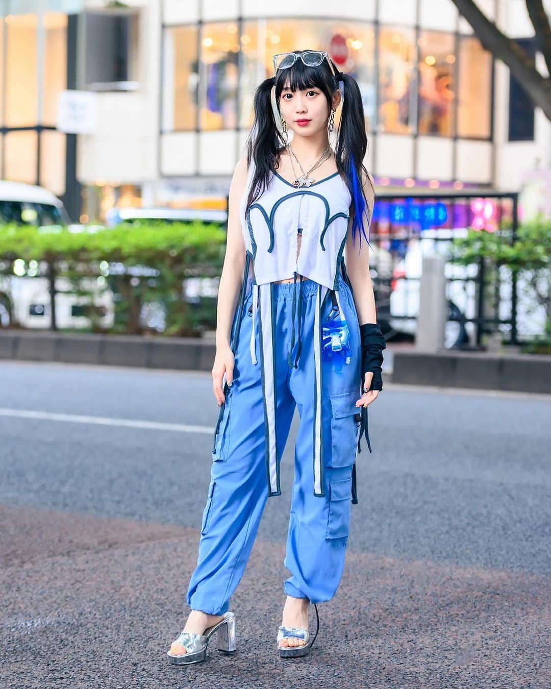 のインスタグラム：「Twin-tailed Japanese Hatsune Miku fan Misuru (@meguharajuku) on the street in Harajuku wearing an MYOB top with hanging straps, blue cargo pants, a Fancy Mental see through waist bag, WEGO accessories, and Office Kiko by Kiko Mizuhara silver chunky heels.」
