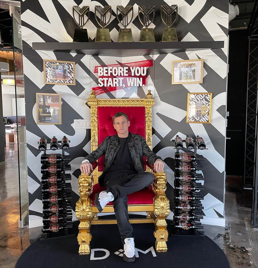 ロブ・ディアデックのインスタグラム：「When we were designing our new @dyrdekmachine offices, I really wanted to create a hero photo moment in my office. Everyone who ever sits in this chair will be blessed by the entrepreneur gods. “Before You Start, Win”  is simply the concept of determining your path to victory before starting.  See it - have a clear vision for what you want to create. Believe it - work the plan until you really believe that you can accomplish it. Do It - take extraordinary action and never stop. We have a custom throne surrounded by our Liquidity Vintages and Exit Trophies. We love to create companies with amazing Do or Diers, but we are venture capitalists who will always judge ourselves by the return on invested capital. We also celebrate by creating two championship trophies and 24 limited edition liquidity vintages of wine. We keep one trophy and 12 bottles then give the others to our co founding partner. This wall is covered in our wins. This is a place of extraordinary good luck and fortune for all of those that sit here.  #manufacturingamazing」