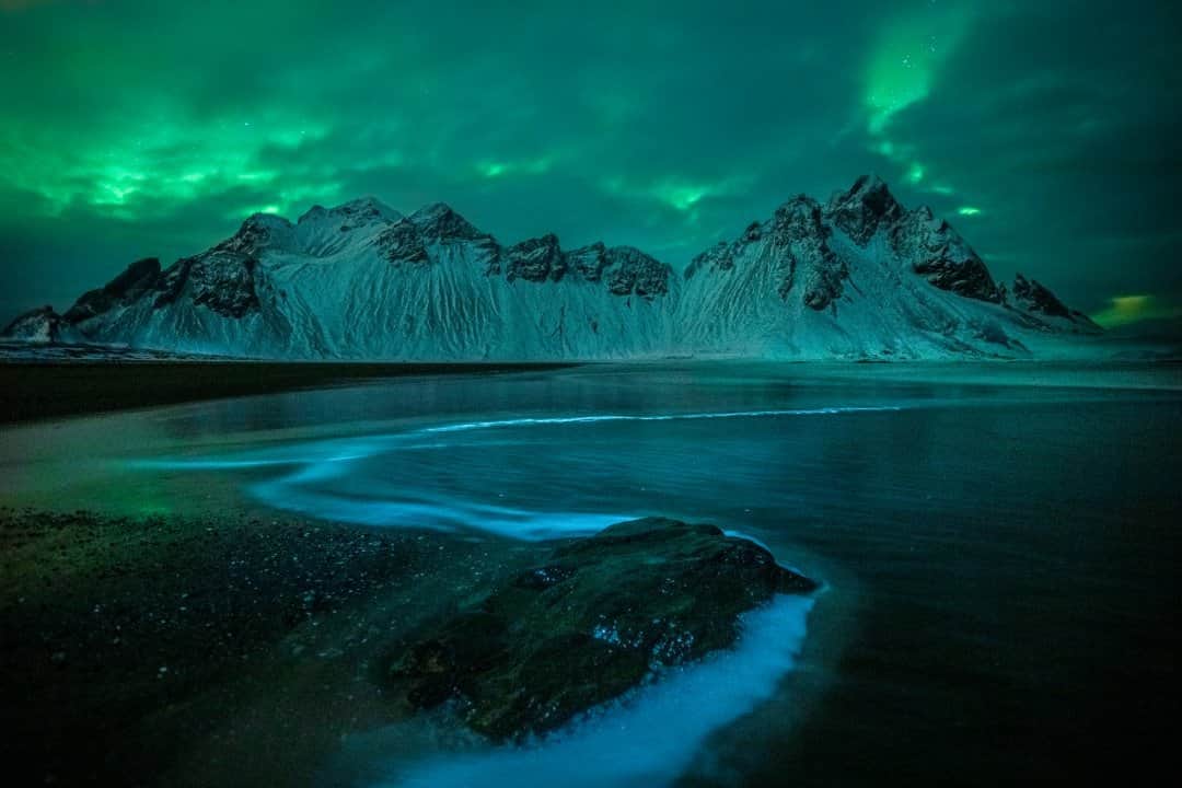 National Geographic Travelさんのインスタグラム写真 - (National Geographic TravelInstagram)「Photo by @kahliaprilphoto / A night of pure magic at Iceland's famous Vestrahorn as the aurora borealis dances behind the clouds, painting the landscape in a green glow.」2月27日 16時39分 - natgeotravel