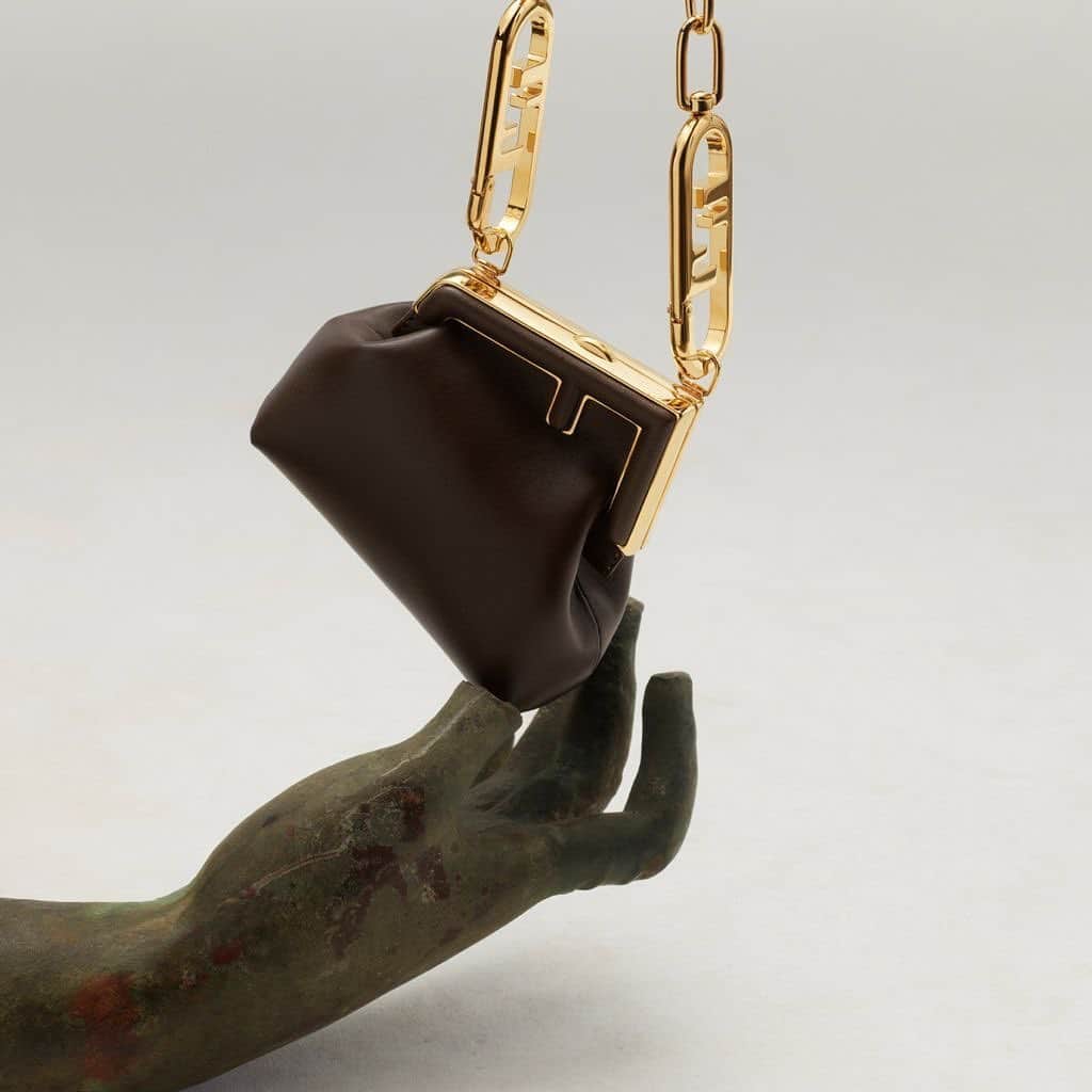 Fendiのインスタグラム：「A key silhouette from the #FendiFW21 runway collection, the Fendi First bag is accented with the tilted #Fendi monogram – seen here in the clutch version.   Artistic Director of Couture and Womenswear Collections: @MrKimJones Artistic Director of Accessories and Menswear Collections: @SilviaVenturiniFendi Jewellery Creative Director: @delfinadelettrez  Creative Director: @Ronnie.Cooke.Newhouse Photographer: @caspersejersenstudio  Antiques: @galerie.chenel」