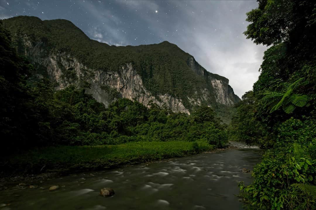 National Geographic Travelさんのインスタグラム写真 - (National Geographic TravelInstagram)「Photo by Robbie Shone @shonephoto / During the scientific research expedition to Borneo's Gunung Mulu National Park in 2018, the team spent a week based on the banks of the Melinau River at Camp 5 in the Melinau Gorge. Camp 5 is a small wooden structure nestled in the gorge between two massifs, Mount Benarat (pictured) and Mount Api. This base offered the team a great starting point to access the nearby caves where the scientists had several sampling sites. At the end of every long and tiring day, it was an amazing feeling to relax while gazing up at the white cliffs of limestone exposing several cave entrances. I remembered climbing to them and exploring the maze of cave passages inside the mountain on previous expeditions some 10 years ago.」2月28日 0時37分 - natgeotravel