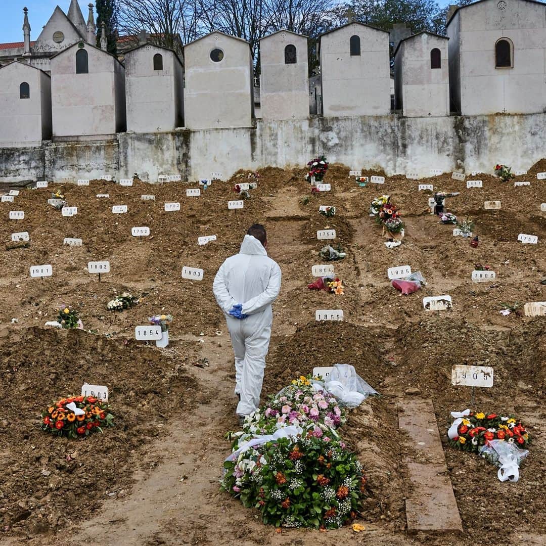 TIME Magazineのインスタグラム：「A gravedigger wearing protective gear walks among fresh plots in between burials of COVID-19 victims at Cemitério do Alto de São João in Lisbon on Feb. 25. Portugal has recorded over 800,000 cases and more than 16,000 deaths, according to data compiled by Johns Hopkins University. Amid a national lockdown earlier this week, @apnews reports, the country's daily tally of new cases dipped below 1,000 for the first time since October. Photograph by Horacio Villalobos—Corbis/@gettyimages」