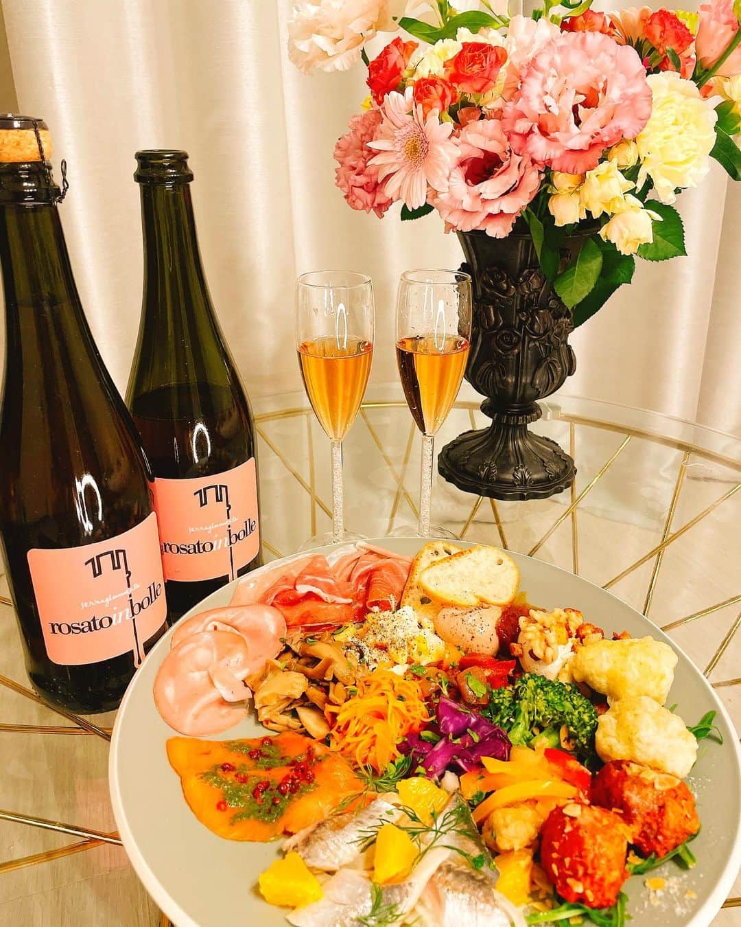 馬場ももこさんのインスタグラム写真 - (馬場ももこInstagram)「素敵なスパークリングワインを﻿ いただいたので休みの日に﻿ お家で晩酌してみたよ😋🍷🍾﻿ 撮影でいただいたお花もあったから﻿ボトルとグラスとお料理とお花と一緒に﻿撮ってみた💐﻿ ﻿ イタリアから直輸入した﻿ ワインや食材を全国に販売している﻿ VERA ITALIA @elio_veraitalia さんの﻿ ロゼのスプマンテ🙆‍♀️🍾✨﻿ ﻿ イタリアのワイナリーに依頼して﻿ オリジナルで作っている他では売ってない﻿ スプマンテなんだって😳🍷✨﻿ イタリア、カラブリア州の会社と﻿ 共同開発して伝統的な葡萄品種﻿ マリオッコを100%使用と🍇﻿ オリジナル商品をありがとうございます✨﻿ ﻿ 飲んだらとてもおいしくて！！！﻿ いちごとバラの香りがするんだよ😳🍓🌹﻿ 色合いもピンクでとても可愛いの😭🌸﻿ ﻿ 喉越しが良くて本当に飲みやすい✨﻿ 1人飲みも楽しくなるしお酒が好きな﻿ お友達呼んで一緒に飲みたくなる味🧡﻿ ﻿ 最近お家飲み増えたし友人のお誕生日や﻿ 記念日のお祝いをするにも﻿ なかなかお店に出向けないから﻿ 家にも置いてお土産にもしたくなる🥂🎁﻿ 素敵な箱に入って届いたよ✨ ﻿ お値段が3000円切るの嬉しくない？😭✨﻿ 全国どこでも注文できるから良き🙆‍♀️✨﻿ ﻿ 前菜の盛り合わせをテイクアウトしたの☺️﻿ ルリイロさん　@ruli_ro  前菜盛り合わせが﻿ ボリュームすごくてスプマンテにも﻿ よく合うお料理ばかり🍽😋﻿ ﻿ VERA ITALIAが半蔵門で経営している﻿ イタリアンレストランにも行きたいな🍝﻿ @eliolocandaitaliana ﻿ ﻿ 本当にありがとうございました🙇‍♀️✨﻿ グラスが２つあるけど動画みてね😂 たまにはお家で飲むのもいいね！﻿ 楽しかった！💃﻿ ﻿ #スプマンテ#ロゼ#ワイン#グラス#スパークリング#スパークリングワイン#🍷#🍾﻿ #お家飲み#おやすみ#良き#休日#おいしい﻿ #幸せ」4月14日 21時19分 - momoko.baba