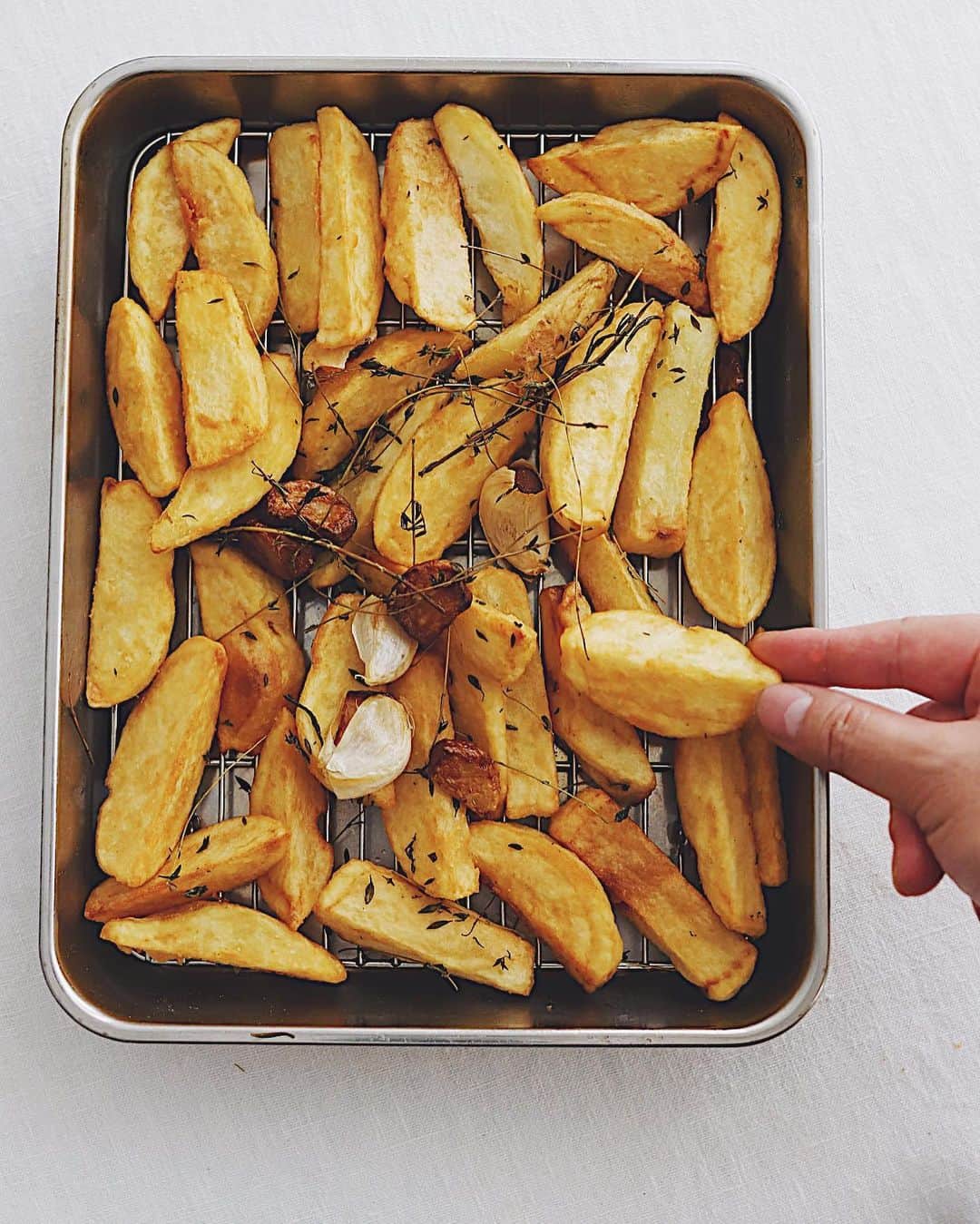 樋口正樹のインスタグラム：「fried potatoes 🍟 . 土曜朝からせっせと揚げた トスカーナフライドポテト。 マルティグラの和知さんの 人気のおいしいレシピです。 . カットは細めより太めが◎。 にんにくは多めがうれしい。 動画は最後の仕上げの強火🔥 . . #ほくほく #あつあつ #フライドポテト #トスカーナフライドポテト #トスカーナポテト #ポテト祭り #夏ポテト#ポテト #ポテト大好き #ビールのお供 #ビールに合う #やめられないとまらない #つまみ食い #friedpotatoes #🍟」