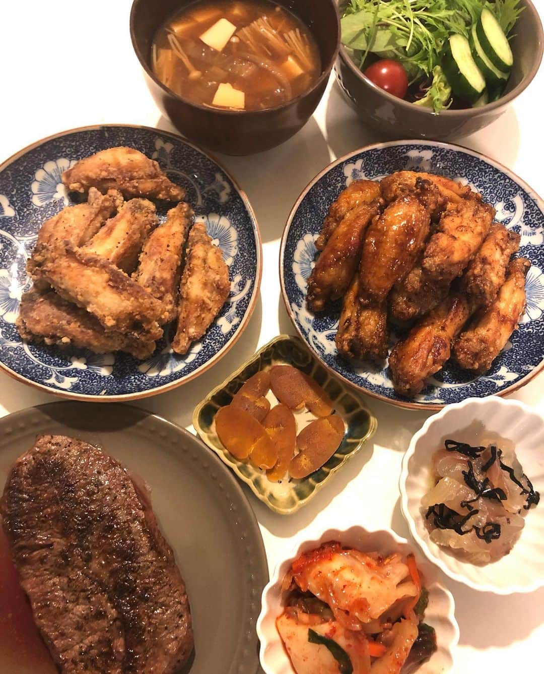 のインスタグラム：「昨日の夕飯( ^ω^ )   塩麹とニンニクのすりおろしにつけて置いた鳥手羽を片栗粉付けて揚げたものです。 胡椒だけかけたバージョンと、醤油、酒、みりん、オイスターソース、甜菜糖を合わせて一煮立ちさせてタレに絡めたバージョン。  タレバージョンの方が好評でした(≧∀≦)  あとは塩麹塗って昆布締めにしておいた鯛を塩昆布と胡麻油で和えて。 キムチとカラスミは自家製。 あとはOKストアで買ったミスジのステーキ、サラダ、味噌汁です(๑>◡<๑) あといただきものの、きびなごのくぎ煮。  食べ過ぎて幸せ〜\(//∇//)\  #甘糟ご飯#ご飯#夕飯#家ご飯#おうちご飯#ステーキ#唐揚げ#自家製#ご馳走様でした」
