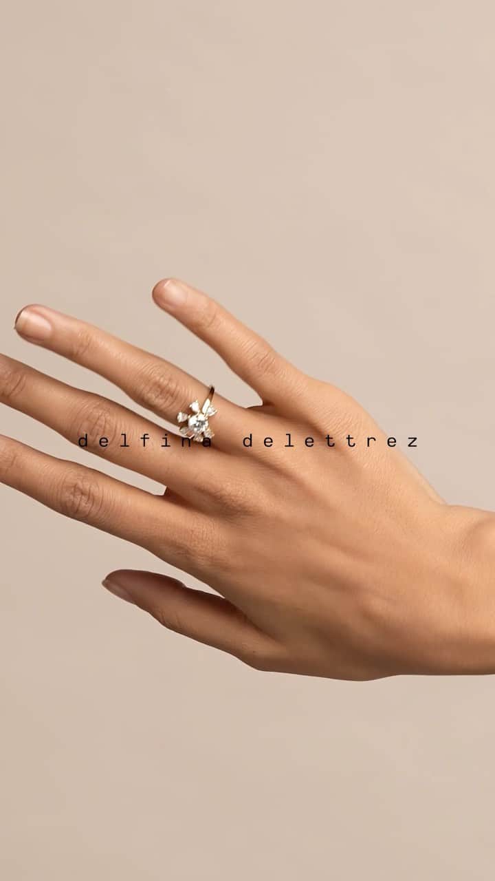 のインスタグラム：「‘Dancing Diamonds Daisy’ ring   Liberating stones from their fixed settings, this ring creates brilliant halos of shifting light given by six diamond charms that rotate like petals in orbit around a central white diamond solitaire   Available in stores & online delfinadelettrez.com   #delfinadelettrez  #delfinadelettrezdancingdiamonds」