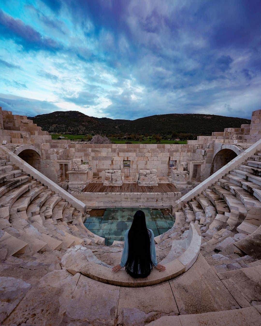 ヘルガ・ラブケティのインスタグラム：「Today in this cloudy day in Patara, the birthplace of St. Nicholas, I pray for peace 🙏 I noticed that the ancient assembly building (bouleuterium) for representatives of Lycian cities and the ancient theater look almost the same, but have completely different purposes.  The participants of the assemblies listened to the representatives and actively participated in making key decisions, while the audience in the theater just sat and watched the performance of the actors.  In this regard, only one quote comes to my mind. God grant me the serenity to accept the things I cannot change, courage to change the things I can, and the wisdom to know the difference」