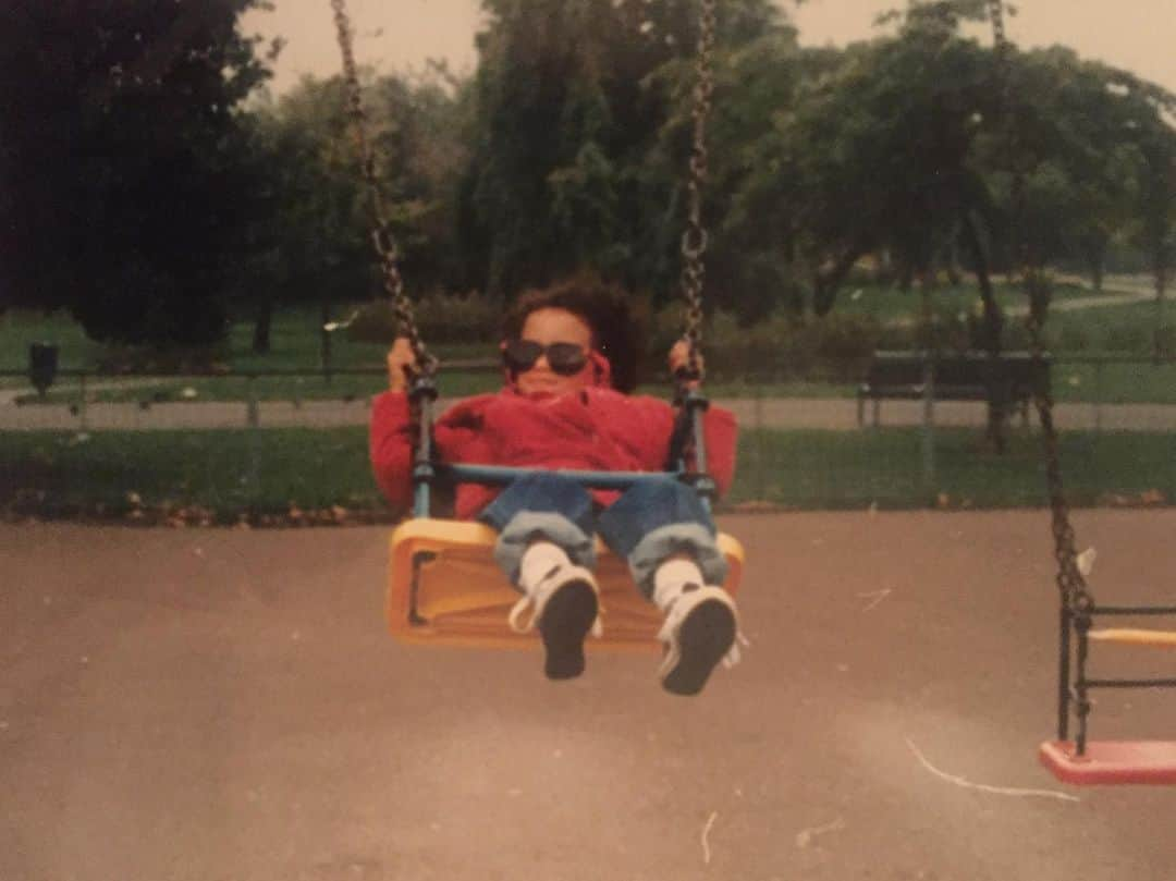 ジョーダン・ロクランさんのインスタグラム写真 - (ジョーダン・ロクランInstagram)「Me swinging into 32. Happy birthday kiddo.   [ID: a very young Jordan on a yellow swing. She is wearing a red jacket, blue jeans, black converse, and oversized sunglasses. An icon.] #HappyBirthday」3月13日 8時32分 - thisisjordanloughran