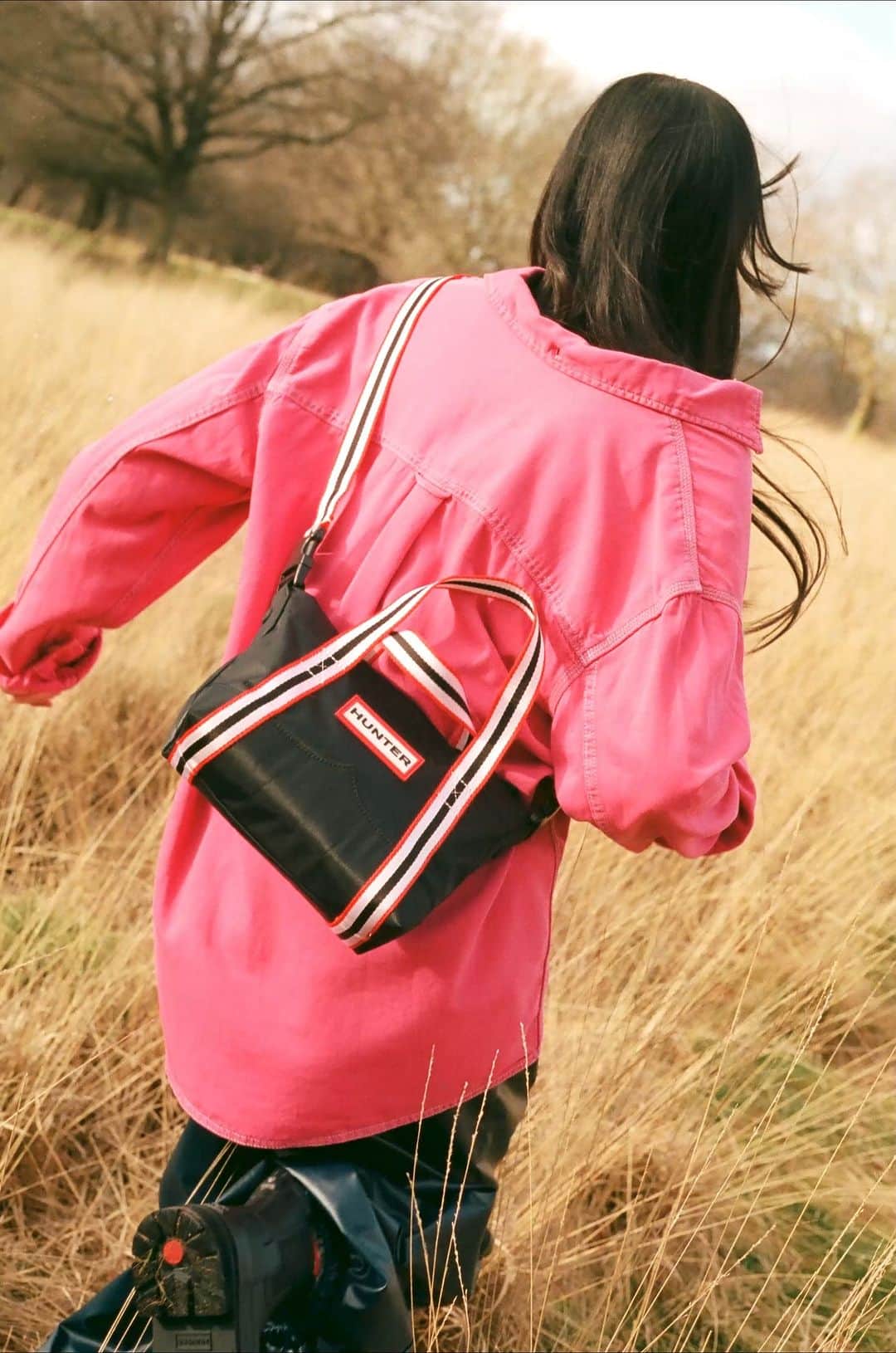 ハンターブーツのインスタグラム：「Running through the fields with our Mini Topclip Tote Bag 🌾 The perfect companion for escaping the everyday.  100% water-resistant inside and out and lined in recycled polyester.   Shop our collection of bags at the link in bio.」